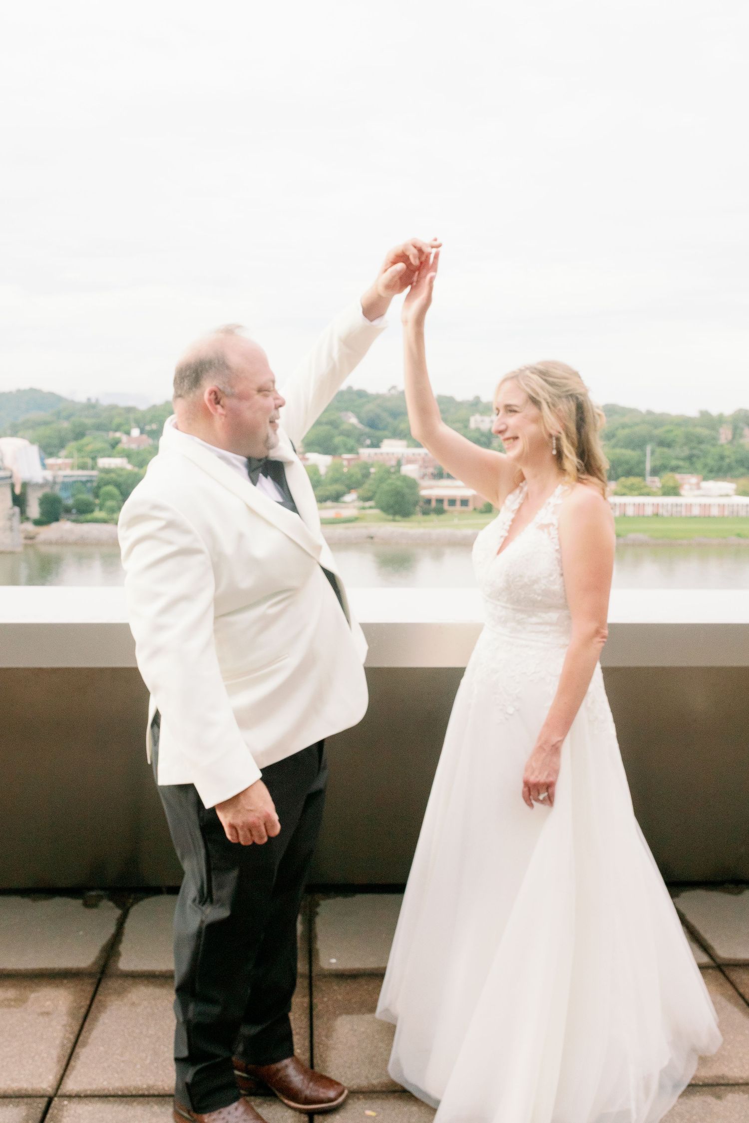 bride and groom hold hands and twirl