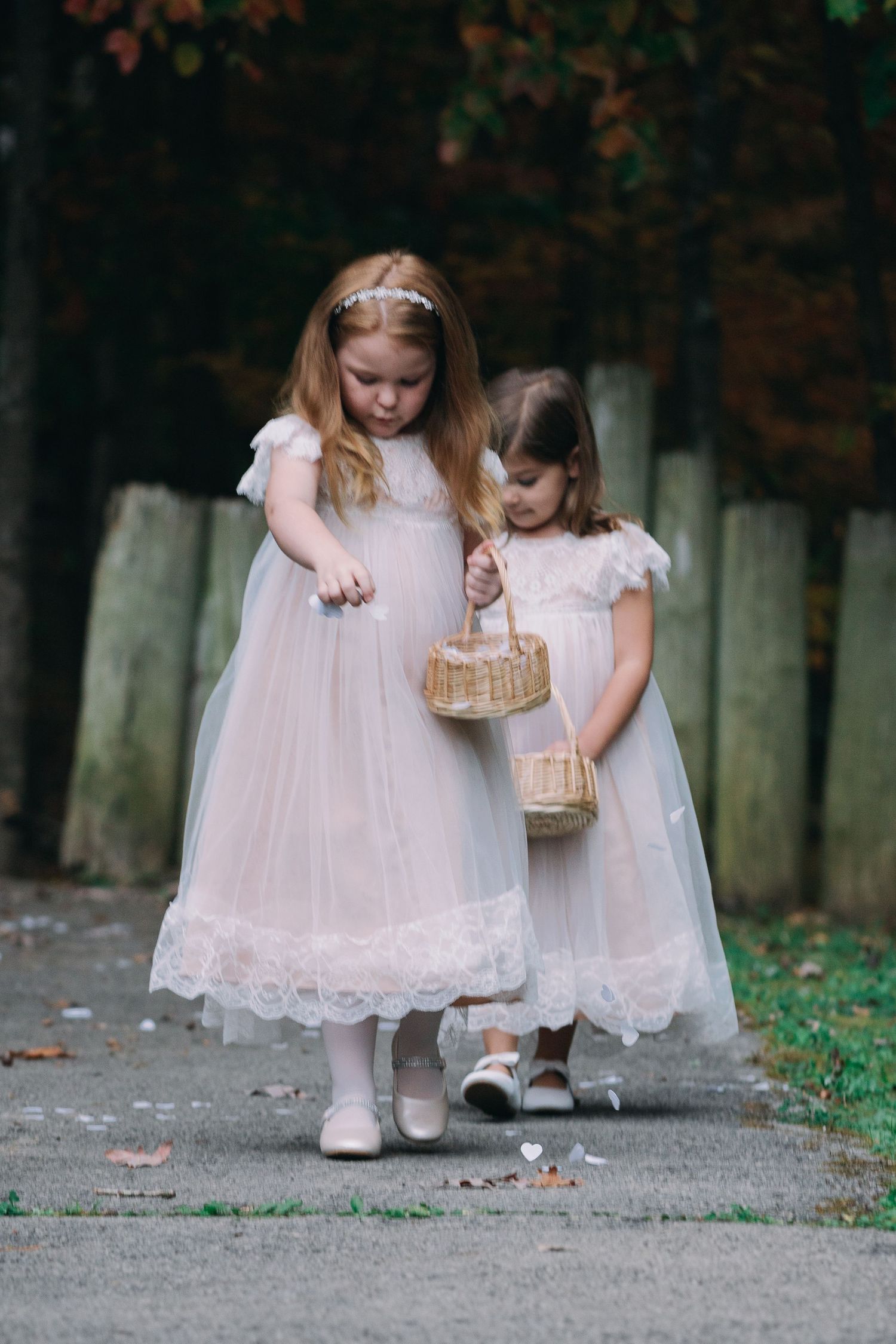 flower girl walking down aisle throwing flowers