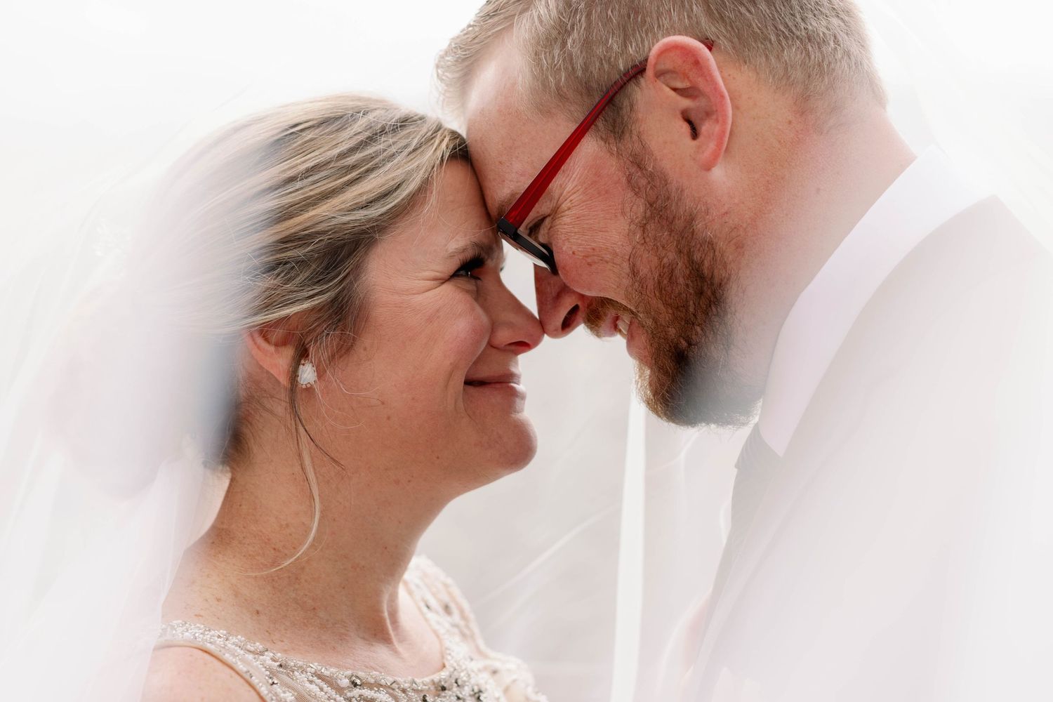 bride and groom under veil in photo
