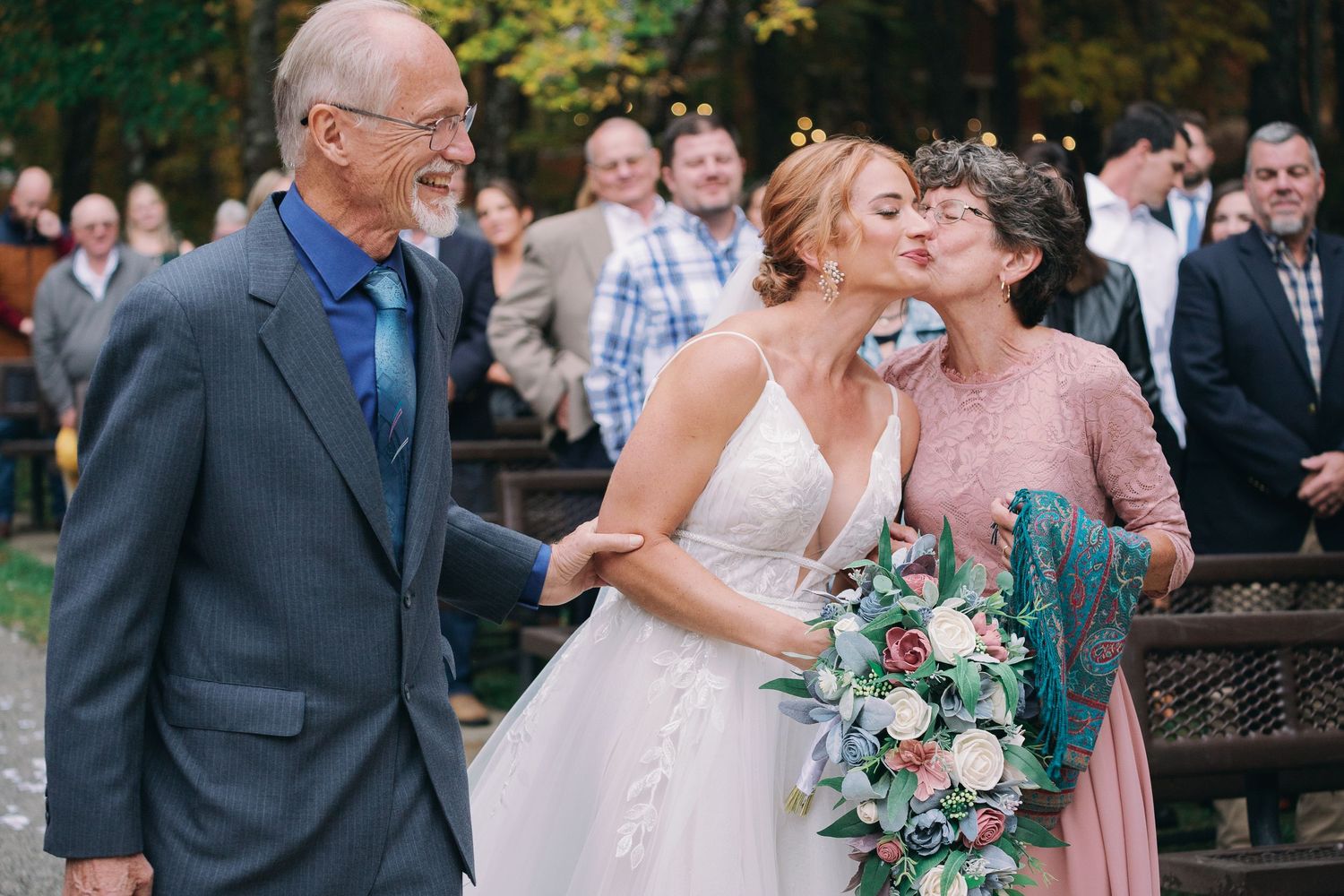 Bride walking down aisle and smiles at groom