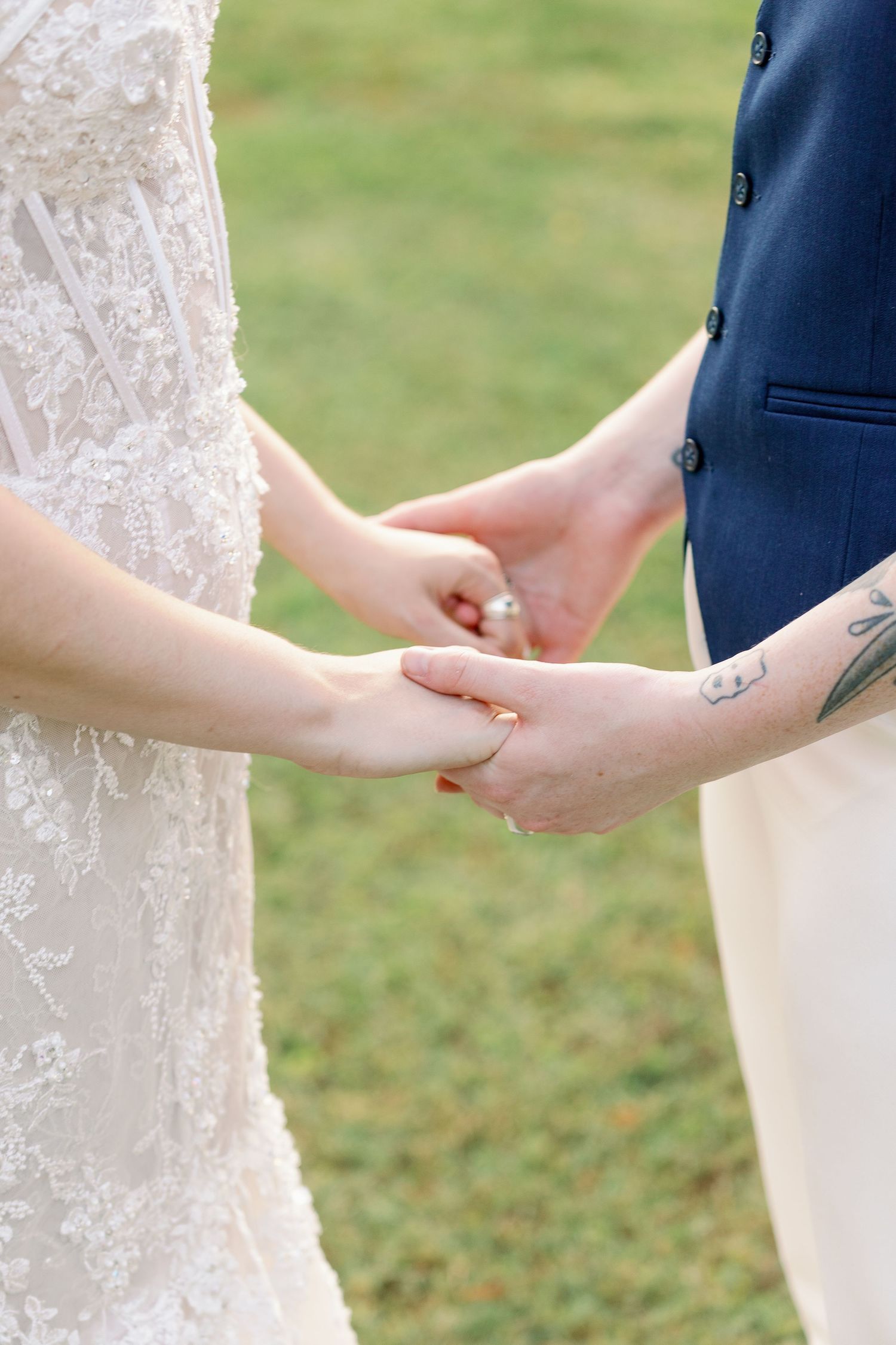 couple holds hands for wedding photo