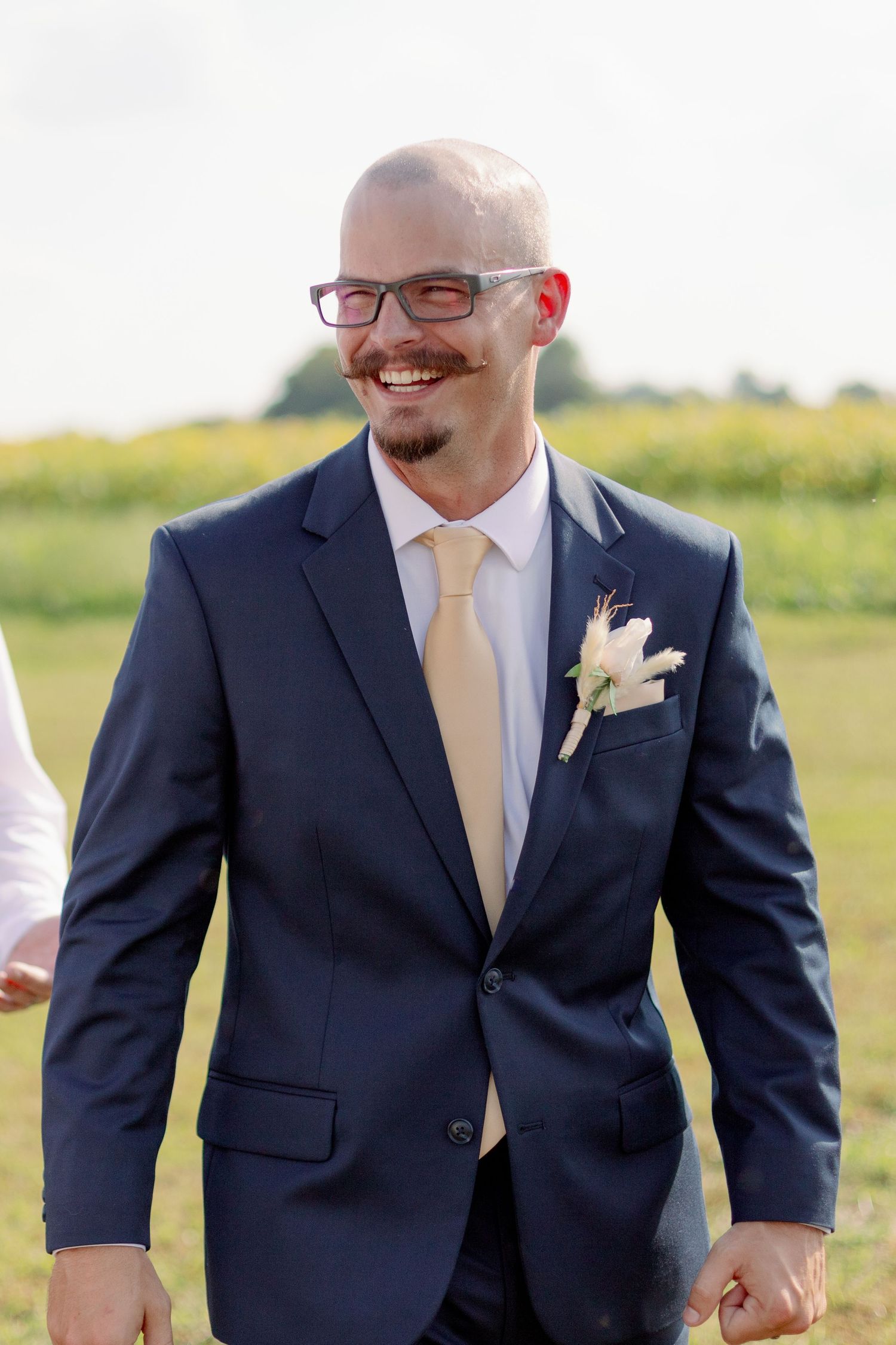 groom smiles in wedding portrait