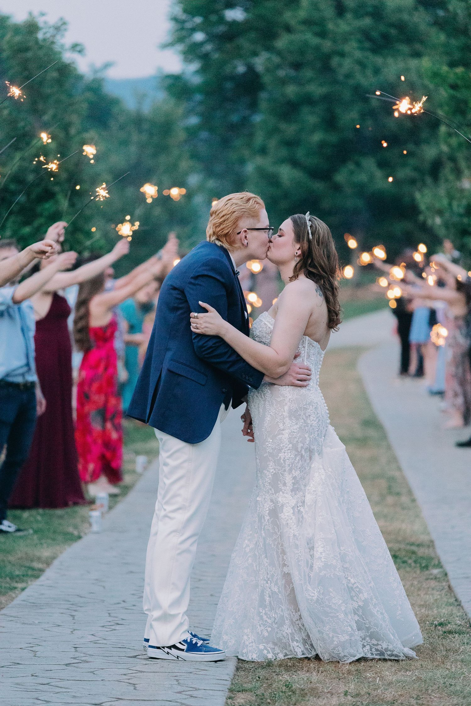 couple kisses eachother in front of sparklers