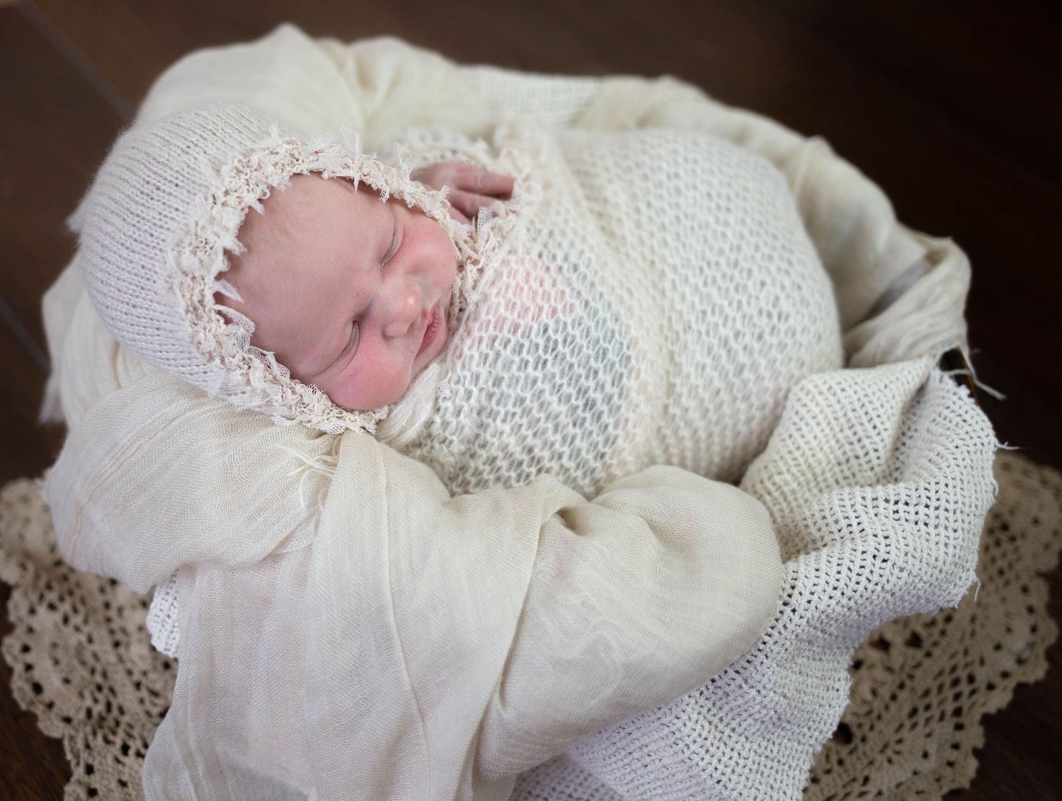 Newborn baby in white lace christening gown sleeping on blanket. Mauston photographer.