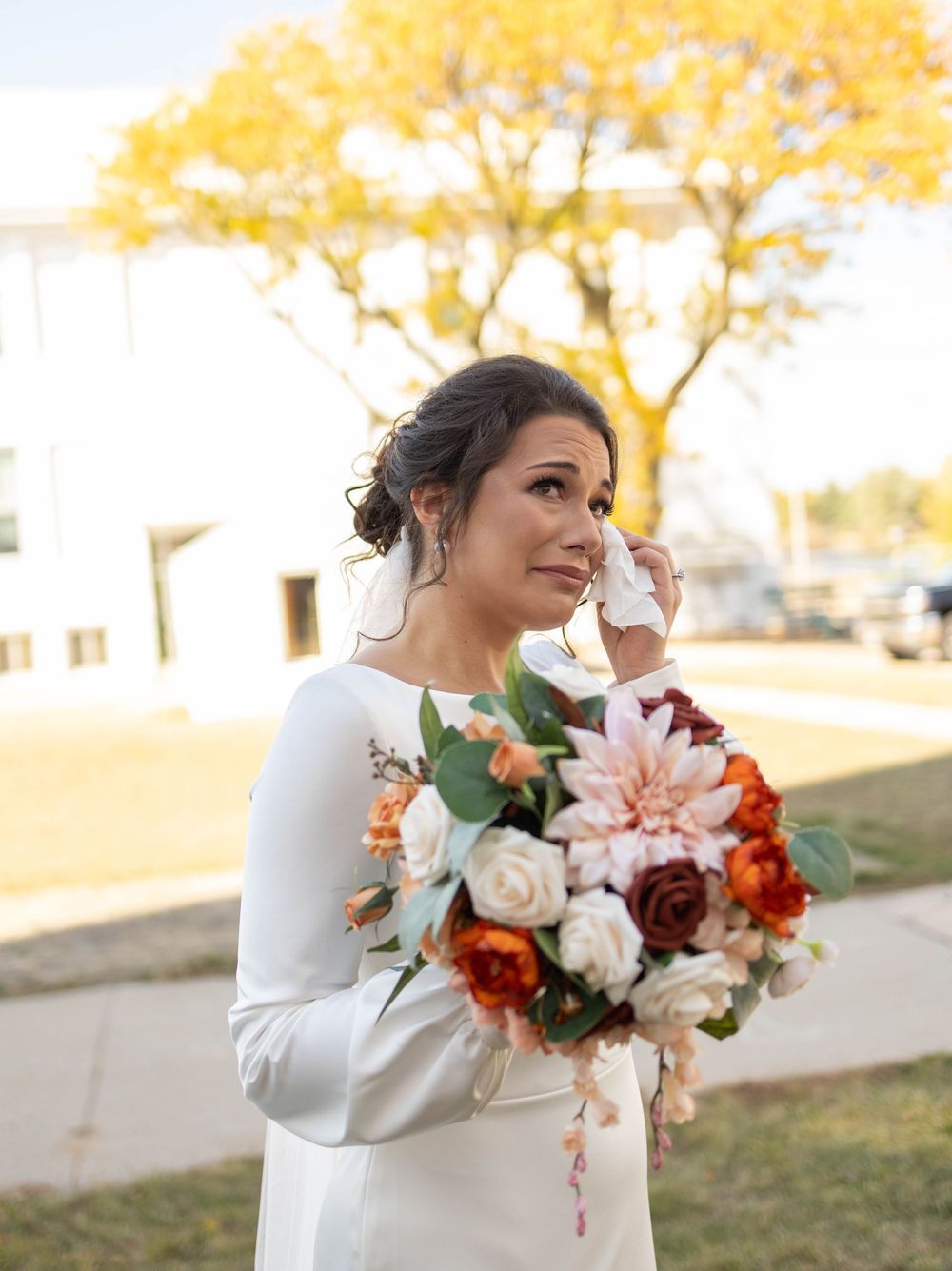 Beautiful autumn wedding bouquet with blush pink and burgundy flowers against a golden sunset background. Mauston photographer.