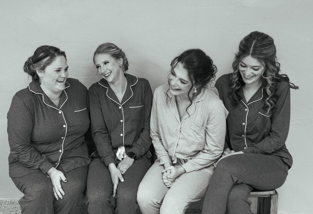 Black and white portrait series showing a group in matching outfits sitting together. Mauston photographer.