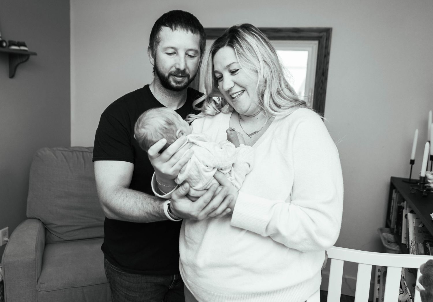 Black and white family portrait showing tender moments with newborn baby. Mauston photographer.