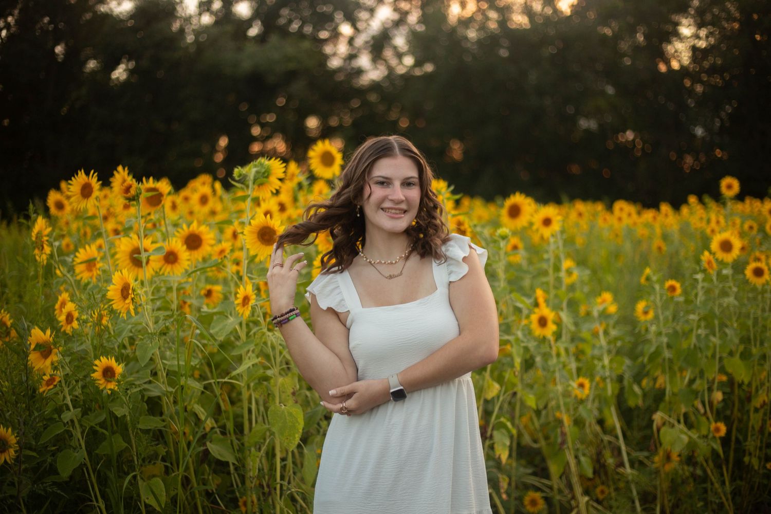 Portrait session in a vibrant sunflower field during golden hour. Mauston photographer.