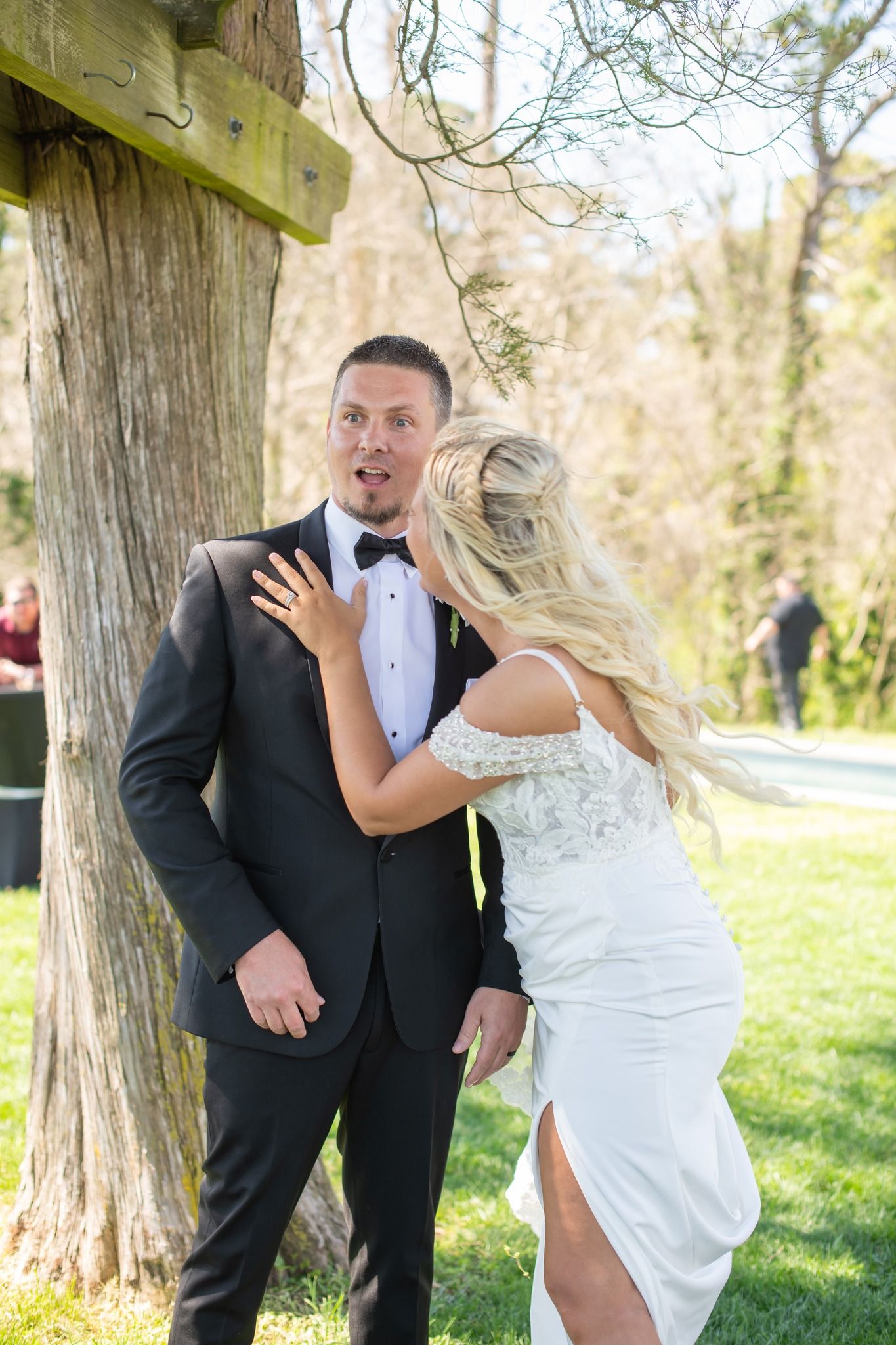 Groom reacts with surprise as bride approaches him during a first look wedding moment.