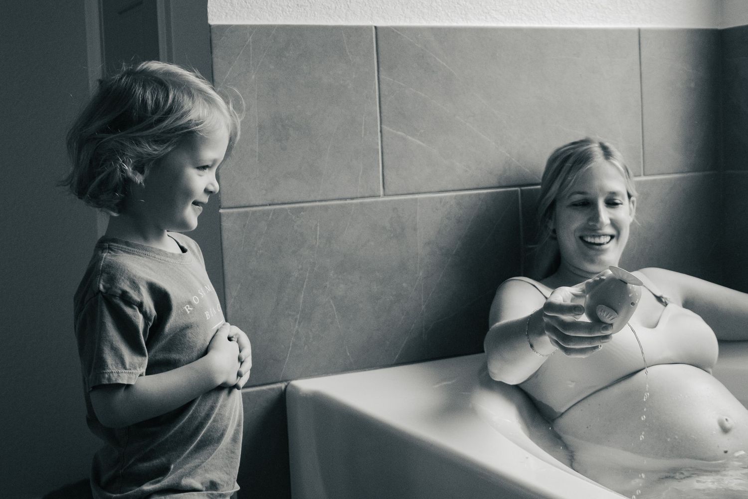 Copperas Cove Birth Photographer captures boy playing with mom while in labor
