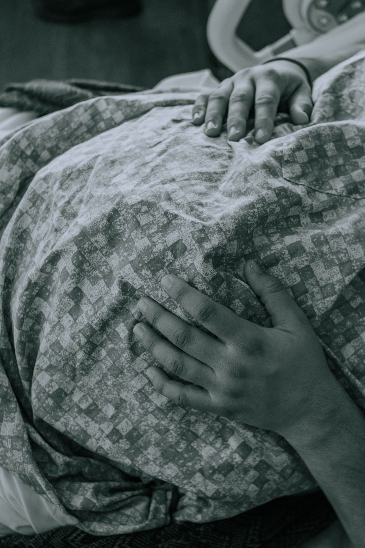 Georgetown Birth Photographer captures mother holding pregnant belly one last time before baby is born.