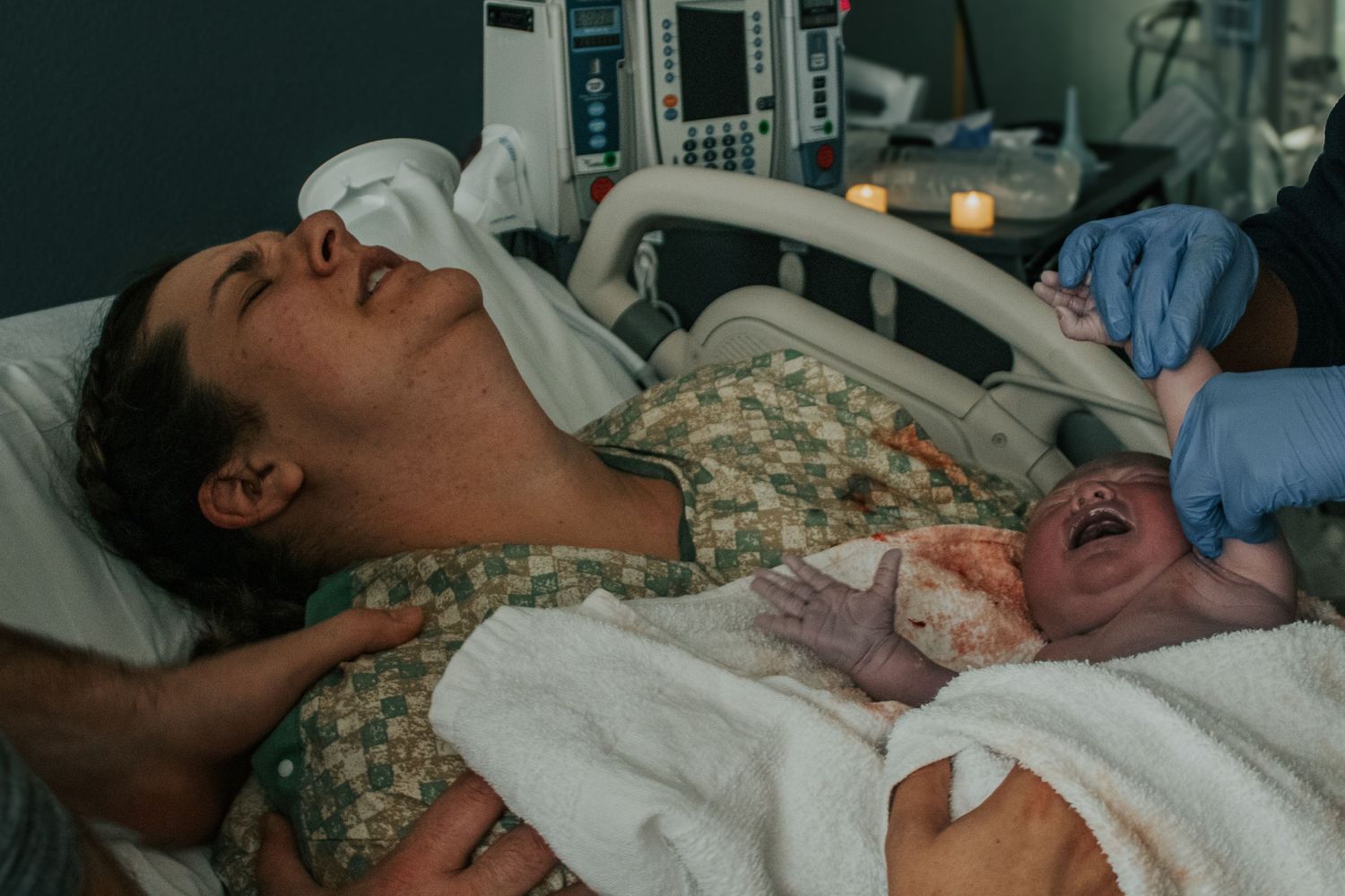 Georgetown Birth Photographer captures the full weight of an after birth contraction after mom delivers her third baby.