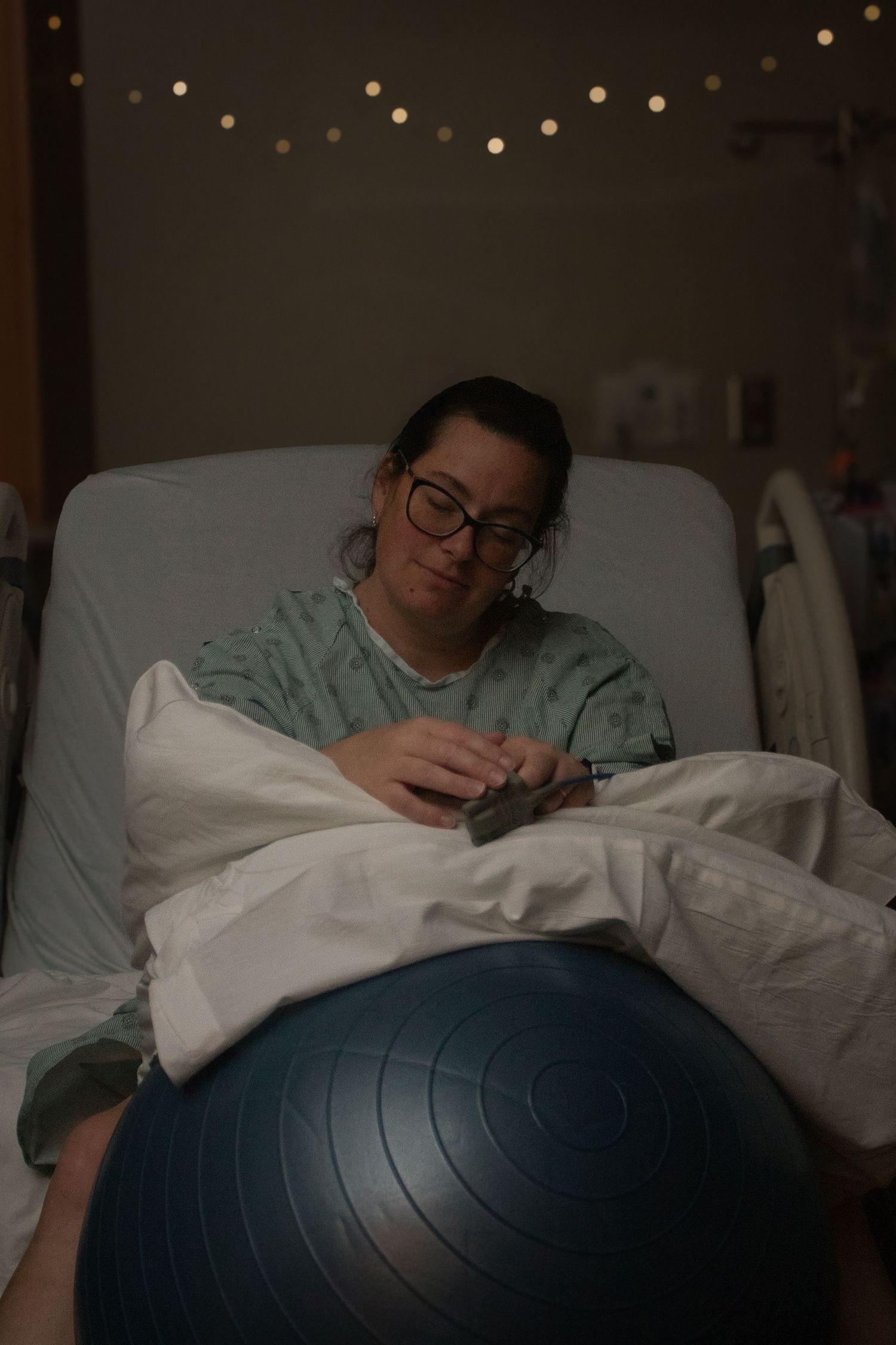 Copperas Cove Birth Photographer captures woman easing into her induction on her birth ball.