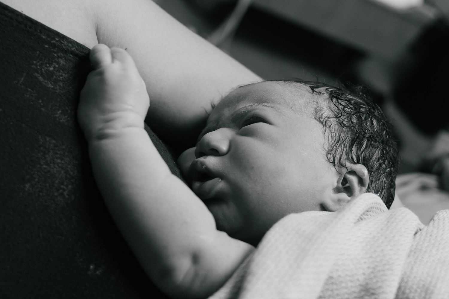Fort Hood Birth Photographer captures baby in mother's arms immediately after her birth.
