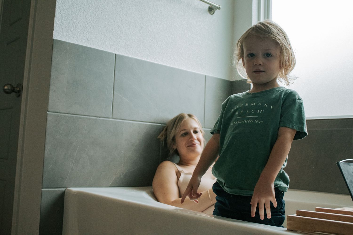 Copperas Cove Birth Photographer captures woman laboring in tub with son.