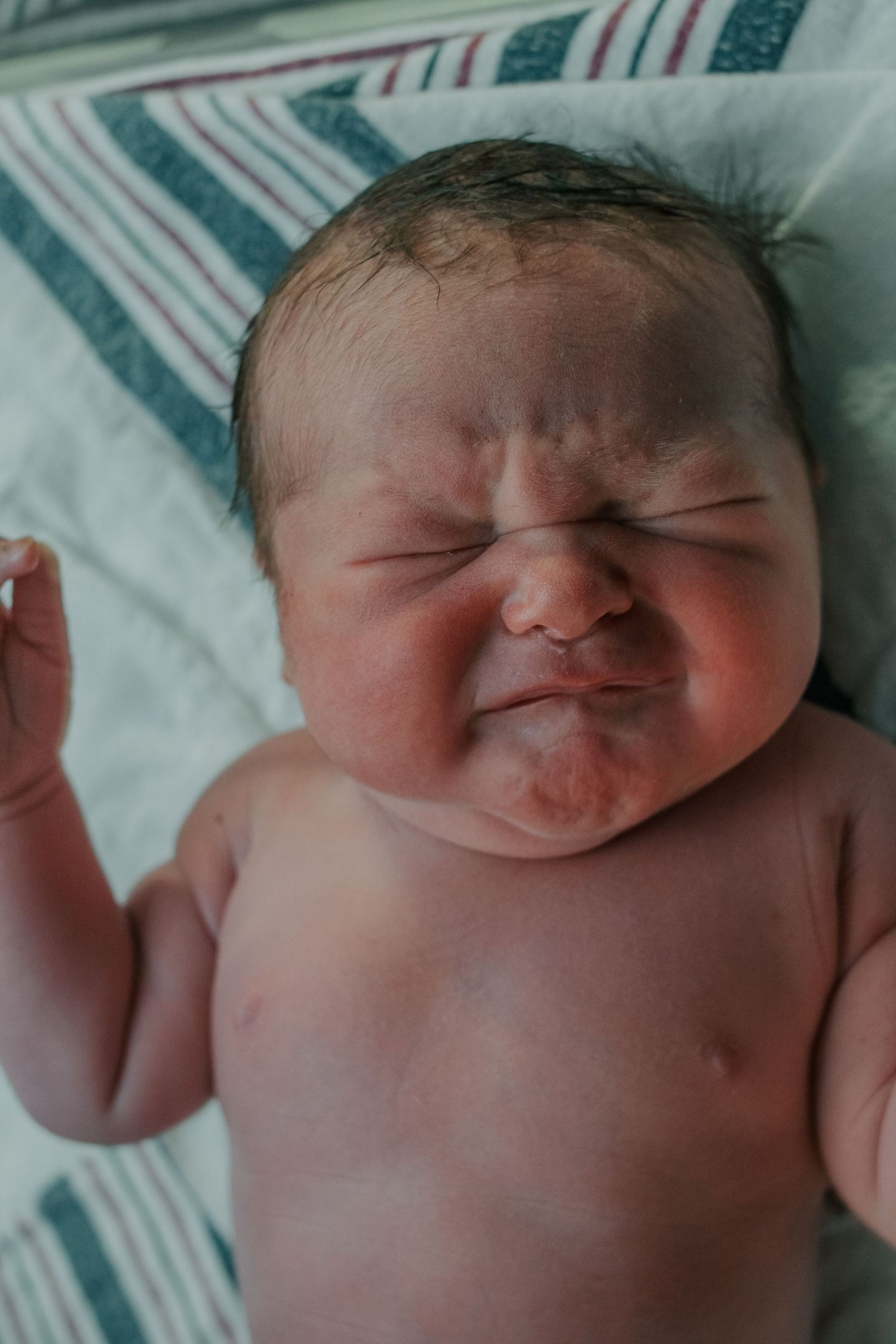 Georgetown Birth Photographer captures newborn baby about to cry