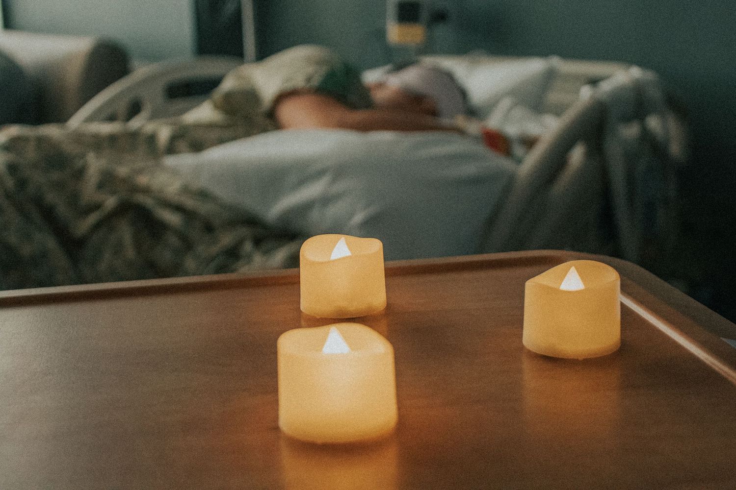 Georgetown Birth Photographer captures mother resting before active labor with beautiful tea lights nearby.