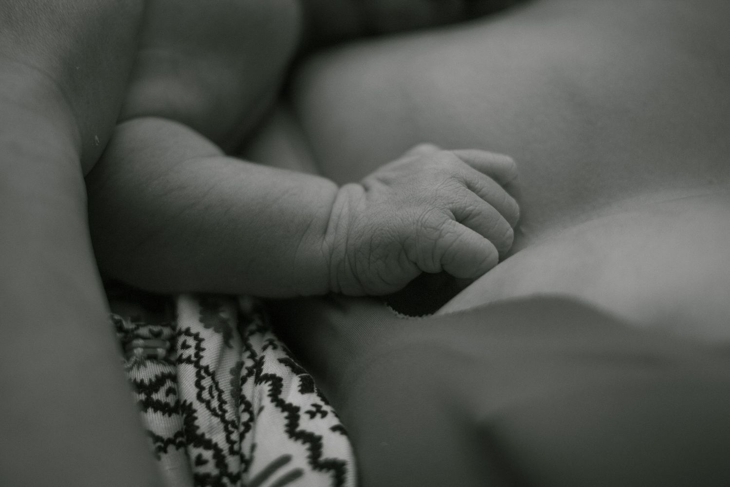 Copperas Cove home birth photographer capturing mother holding newborn baby moments after birth.