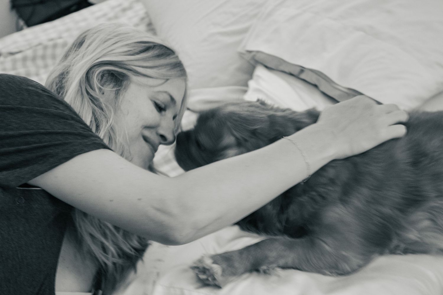 Copperas Cove Birth Photographer captures mother loving on dog while in labor.