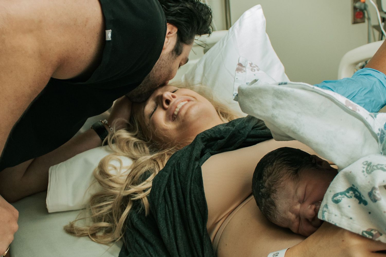 Copperas Cove Birth Photographer husband kissing mother's forehead immediately after birth
