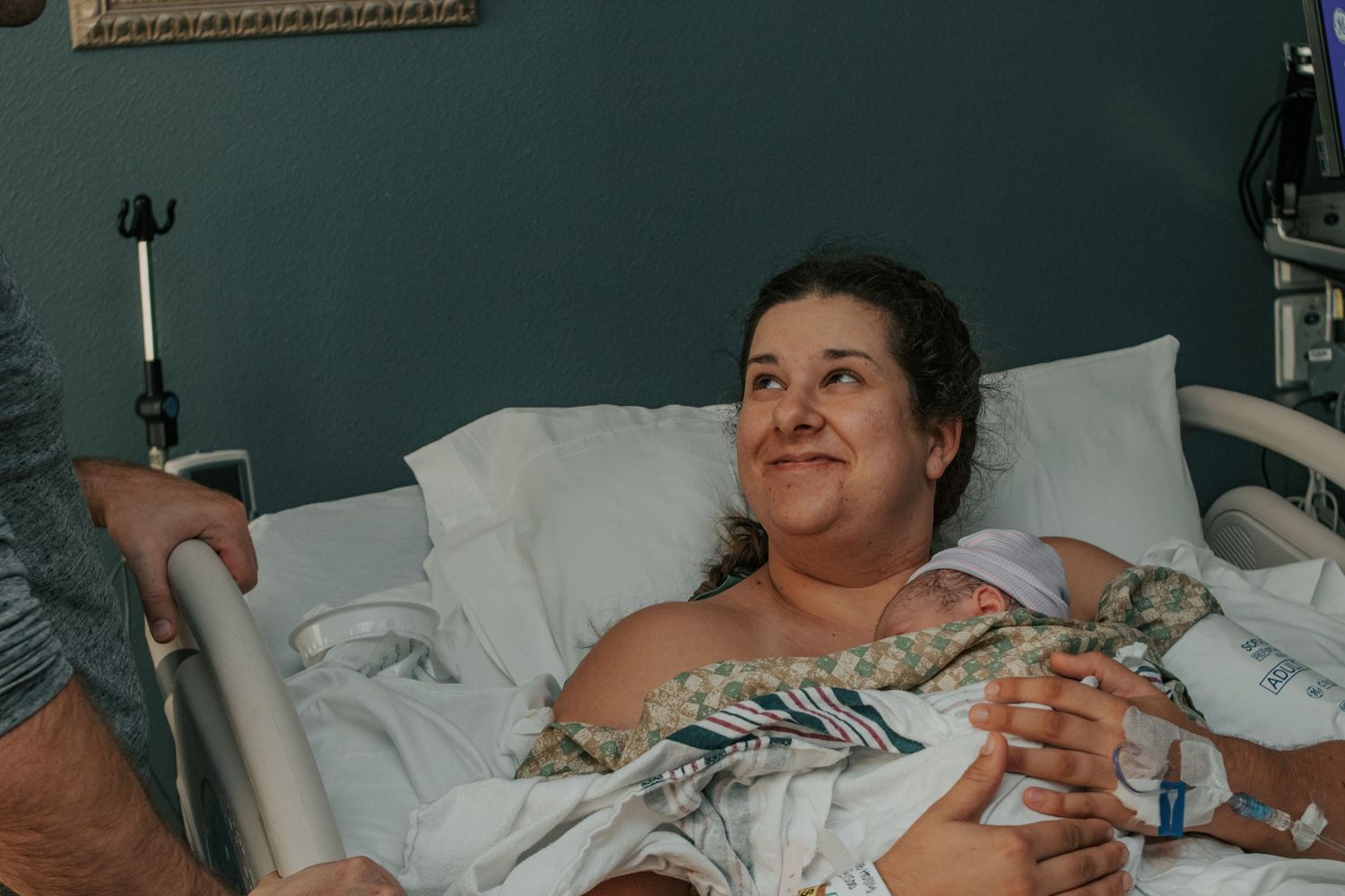 Georgetown Birth Photographer captures mother smiling up at her husband after an incredible birth.