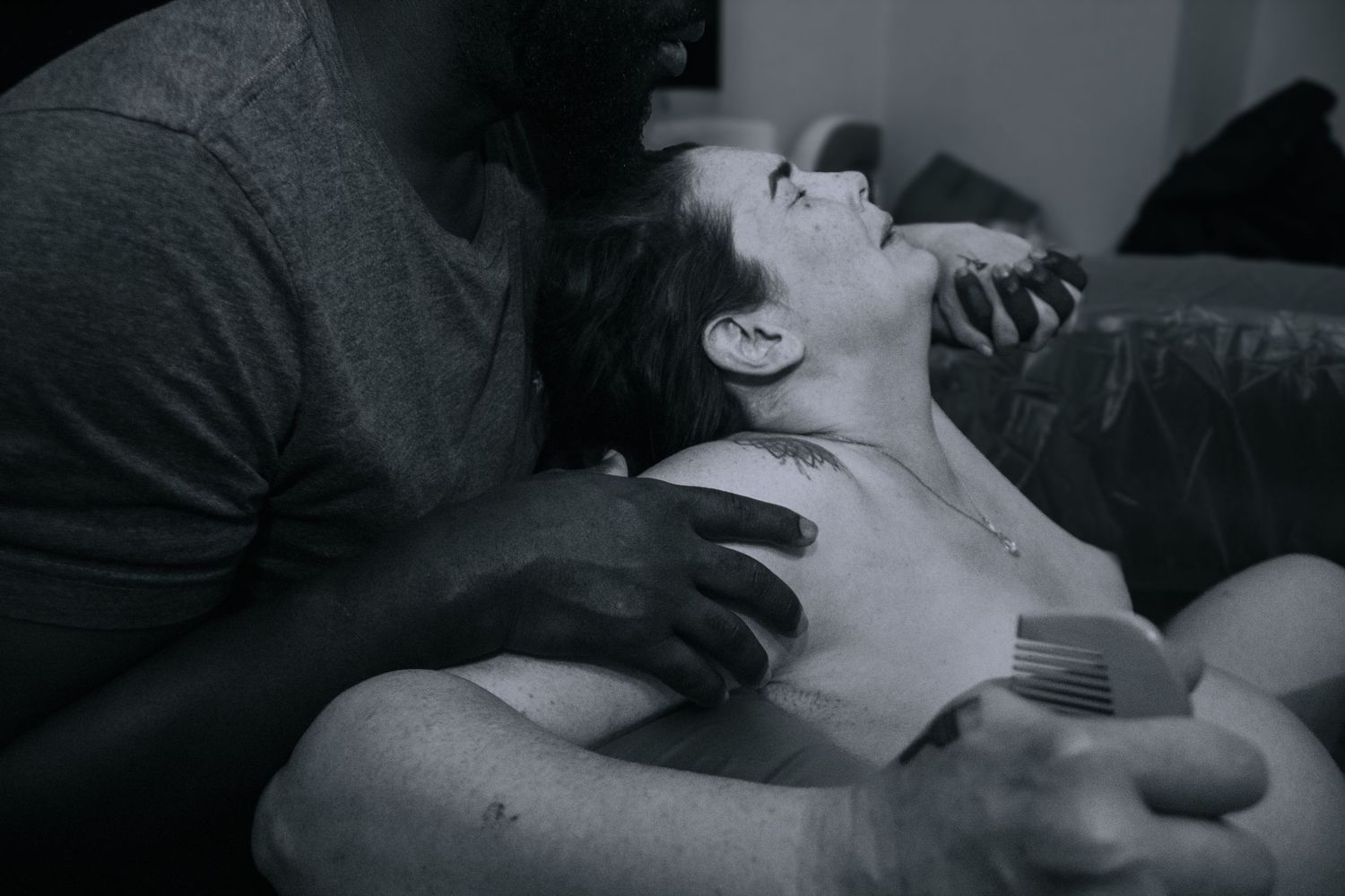 Killeen Home birth doula captures father supporting mother in home water birth