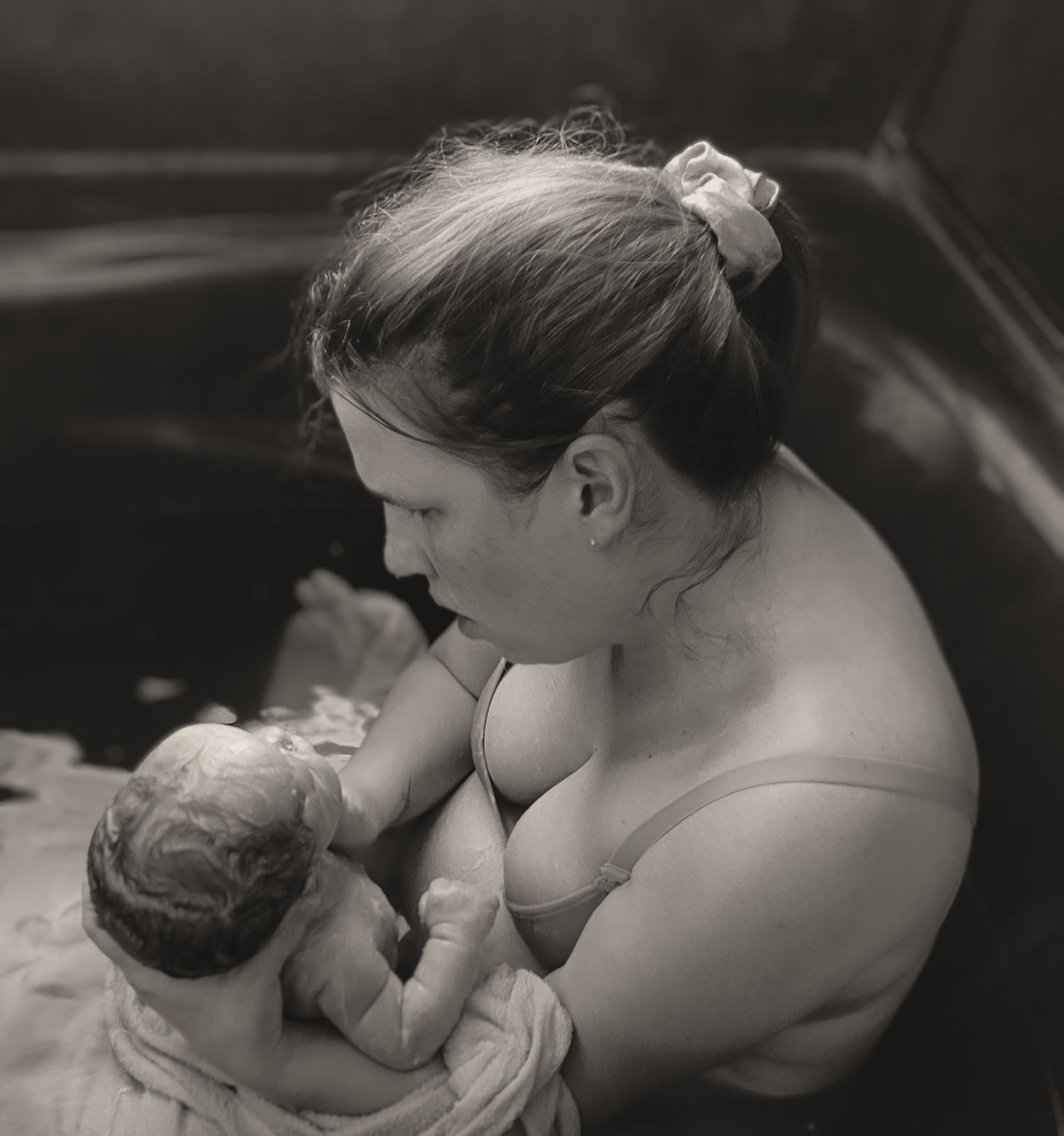 Copperas Cove home birth photographer capturing mother holding newborn baby moments after birth.