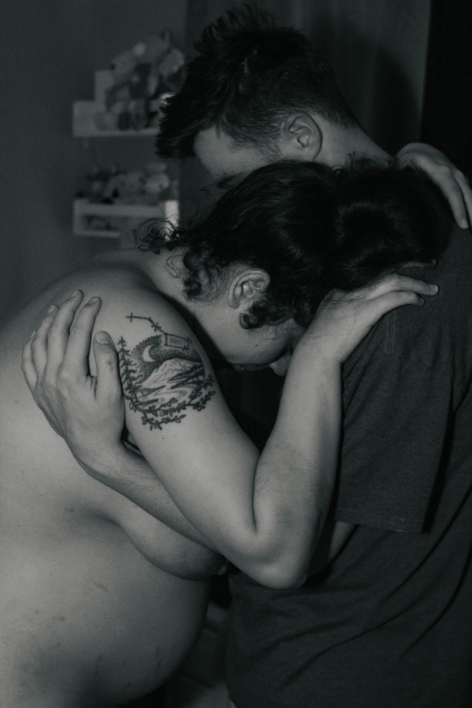 Fort Hood Birth Photographer captures husband holding up wife during active labor.