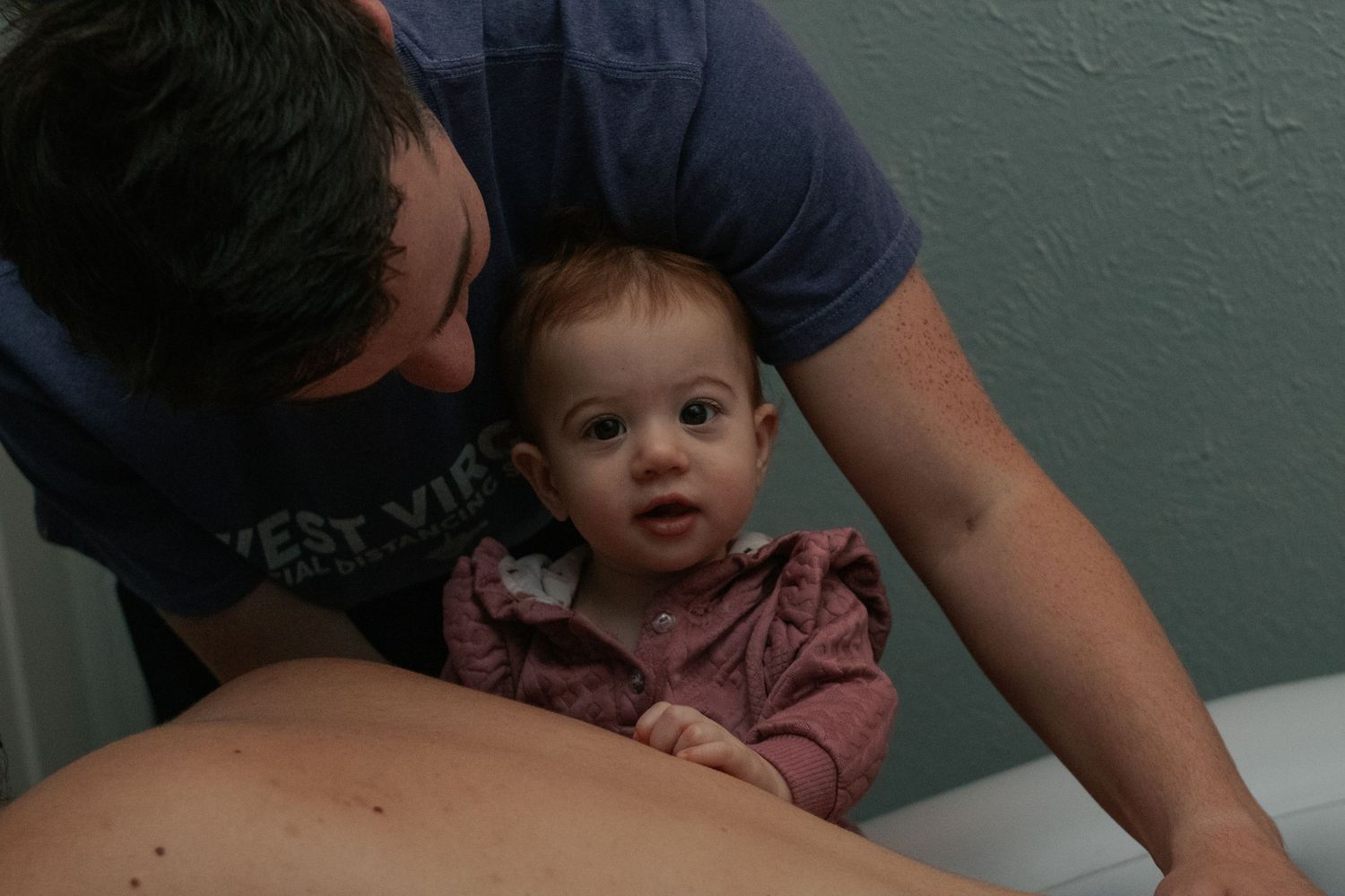 Fort Hood Birth Photographer captures toddler supporting mom in labor.