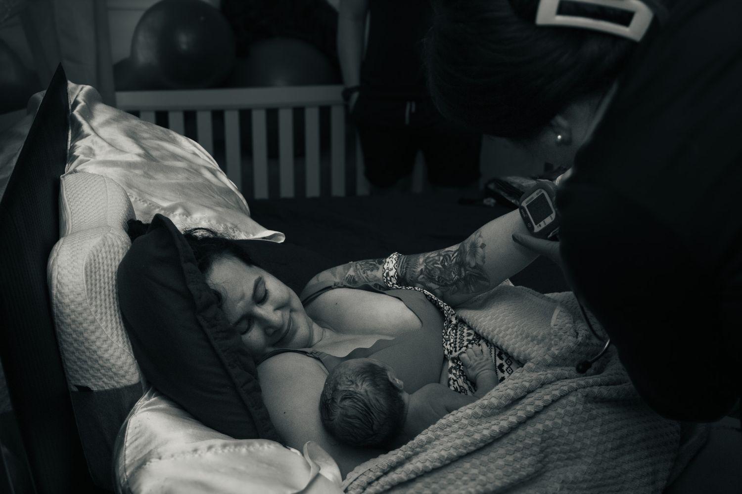 Harker Heights Mom holds newborn baby in her bed after precipitous homebirth.