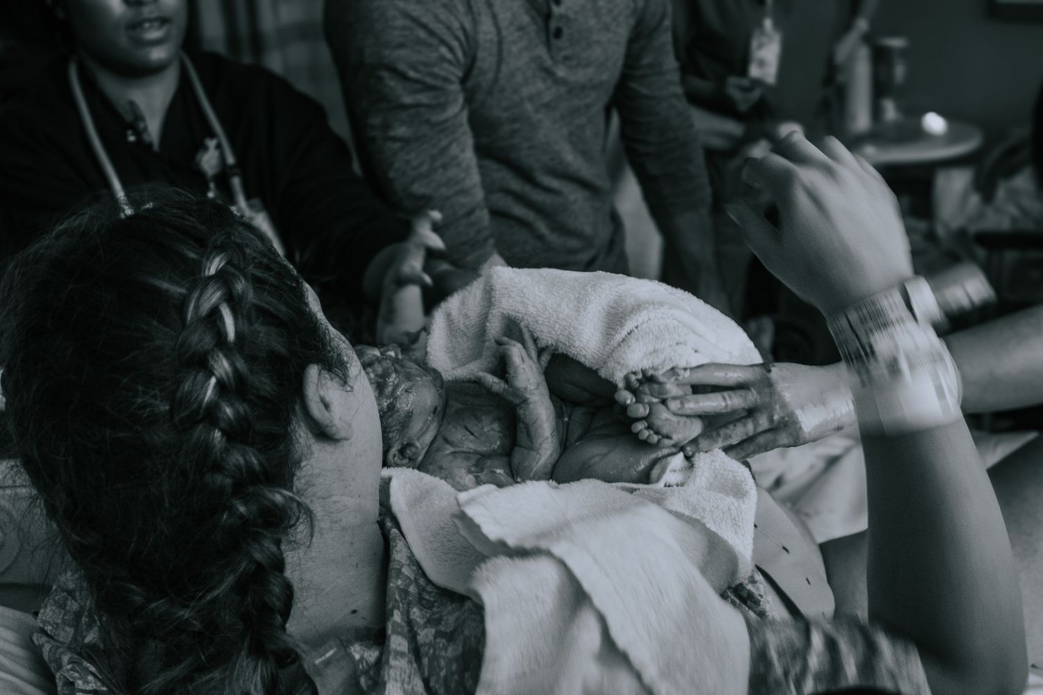 Georgetown birth Photographer captures mother holding baby for the first time after birth.