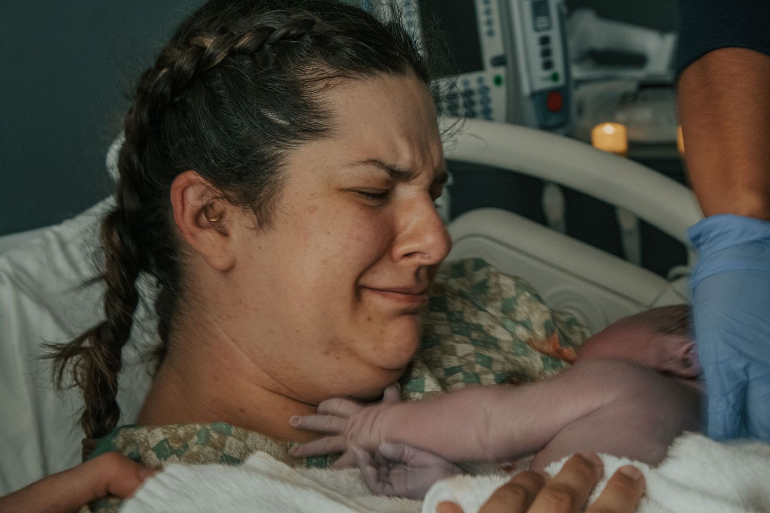 Georgetown Birth Photographer captures the moment a mother cries tears of joy and pride after delivering her baby.