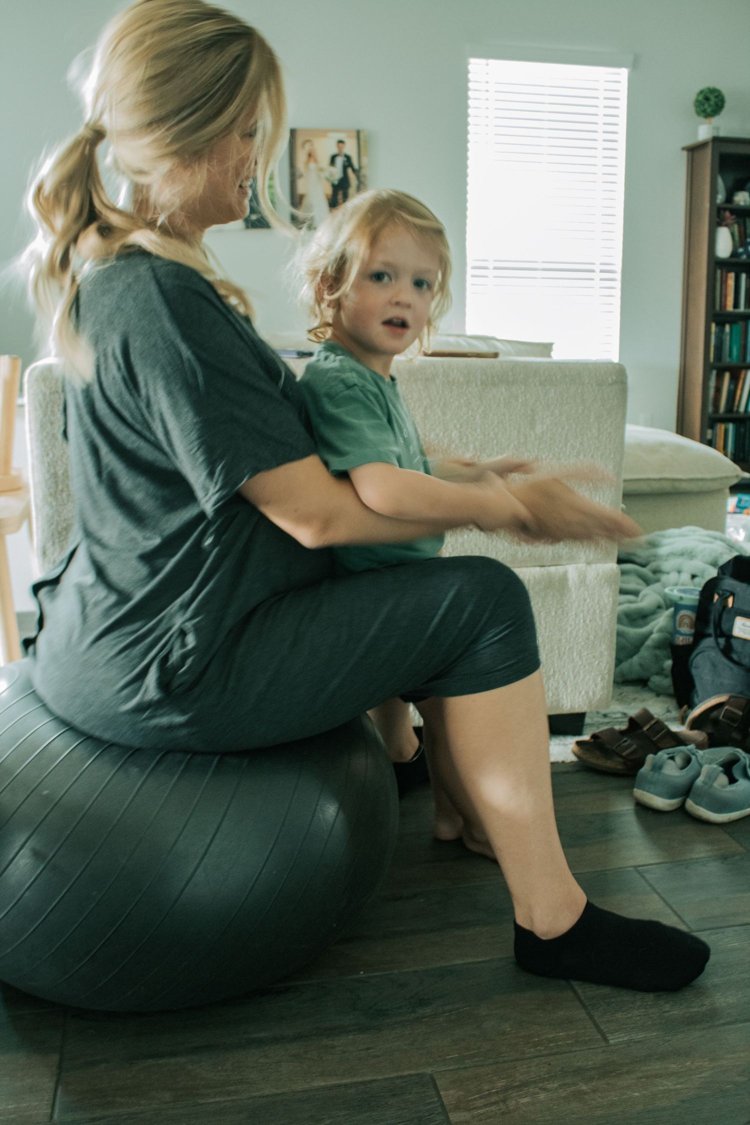 Copperas Cove Birth Photographer captures woman laboring on birth ball holding son.