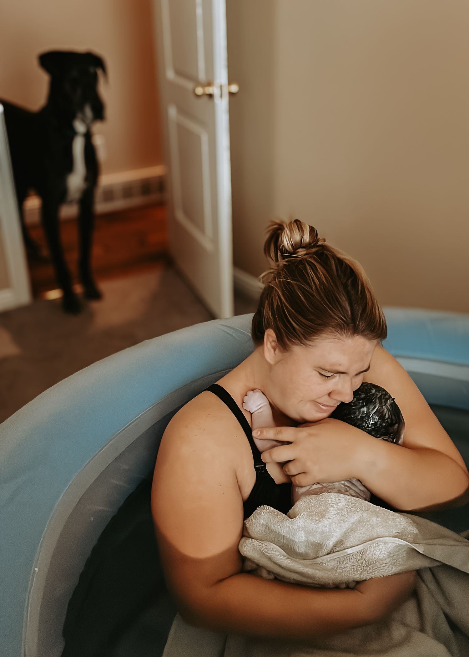 copperas cove homebirth doula holding newborn baby after birth.