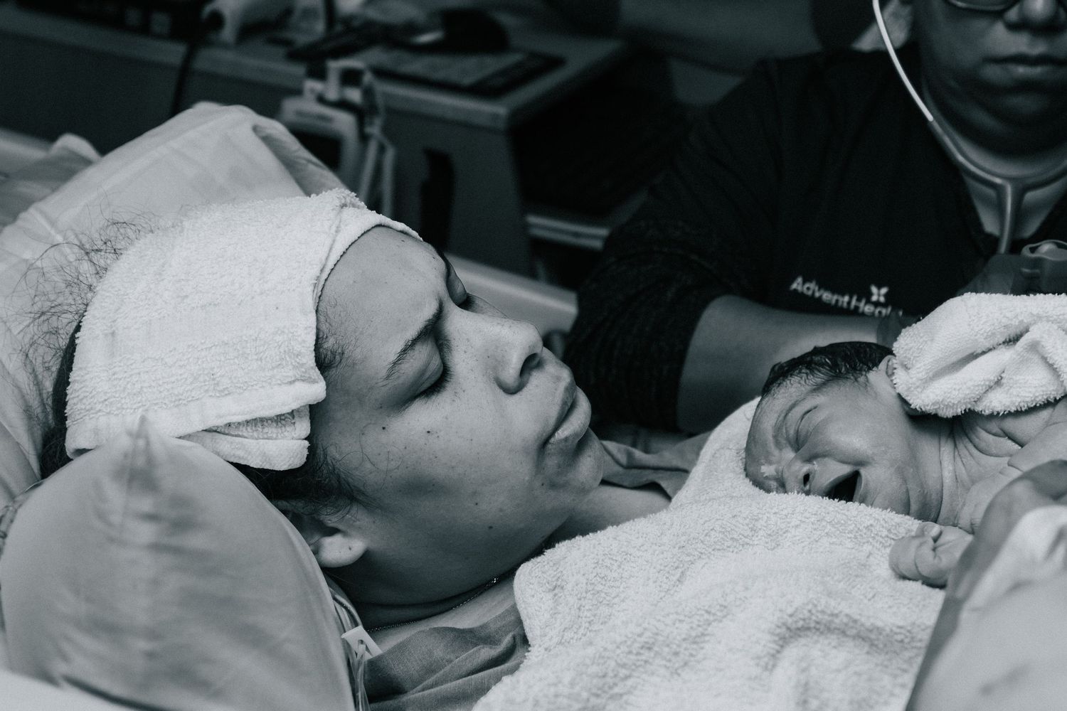 Killeen Birth Photographer captures mother pushing out the placenta with her new baby in her arms.