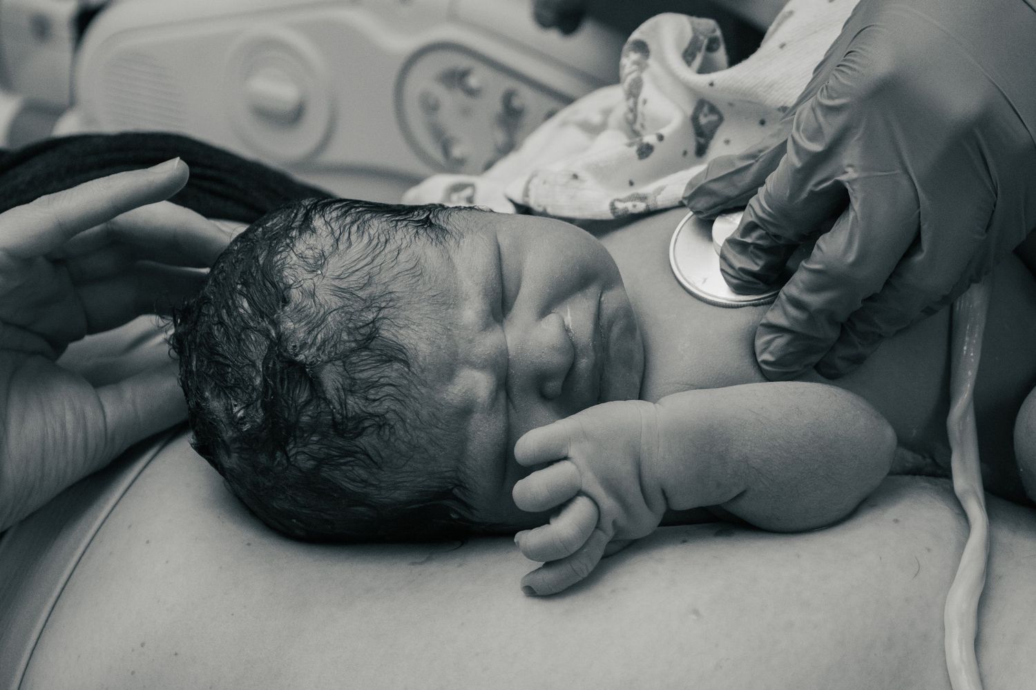 Copperas Cove Birth Photographer baby receiving vitals on mom's chest.