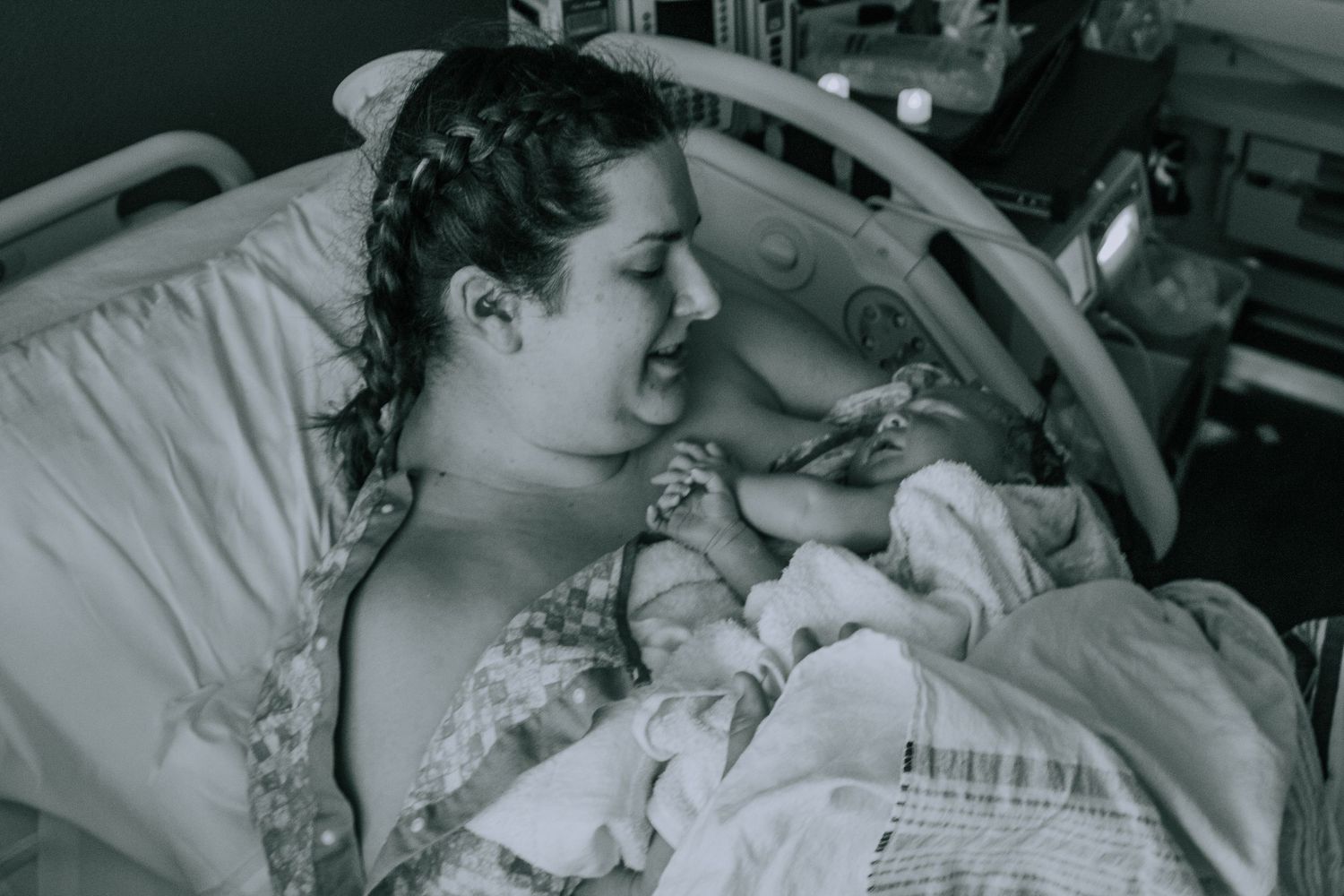 Georgetown Birth Photographer captures mom smiling at baby moments after giving birth.