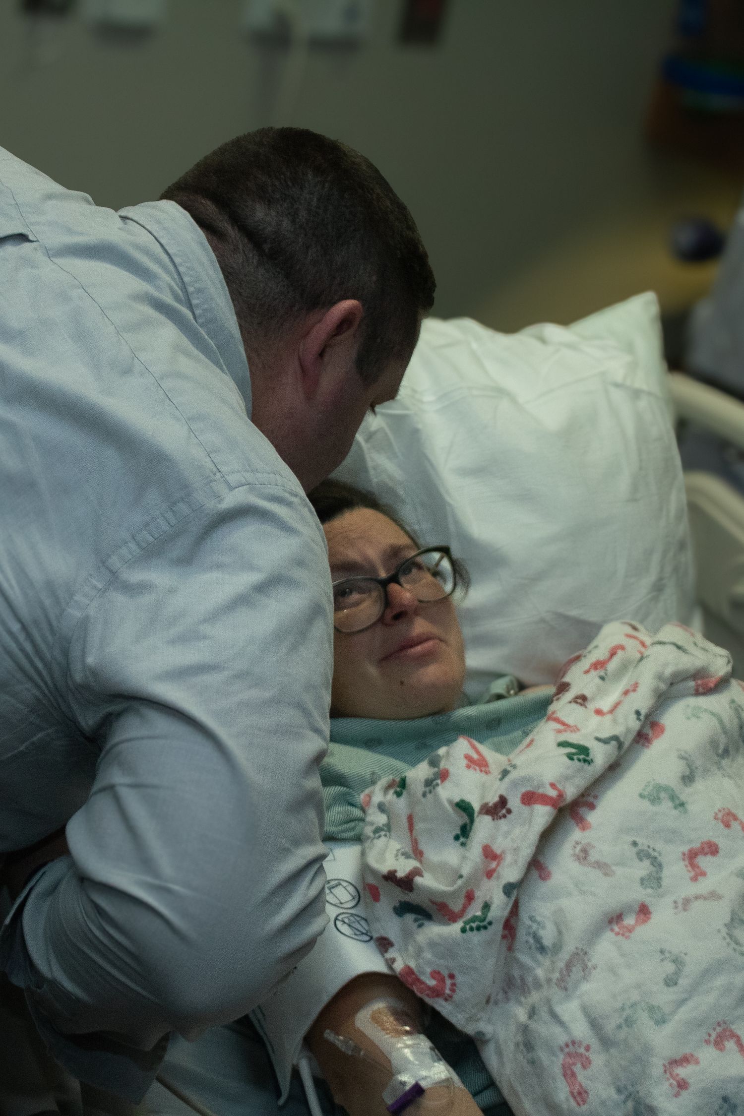 Copperas Cove Birth Photographer captures husband celebrating wife's accomplishments after difficult labor.