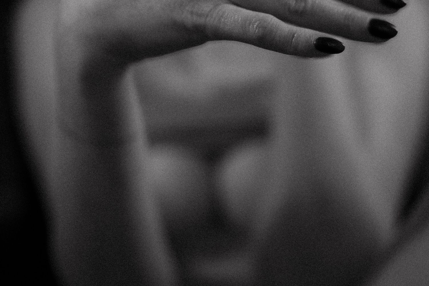 Black and white close-up study of hand gestures in shadow.