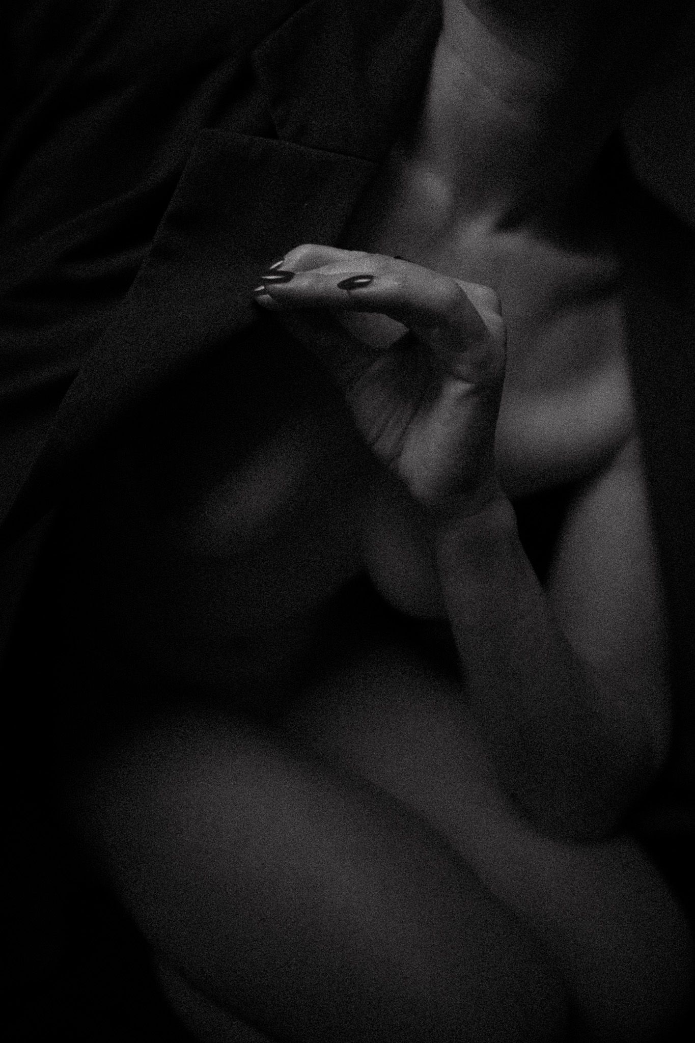 Abstract black and white composition with subtle forms emerging from darkness.