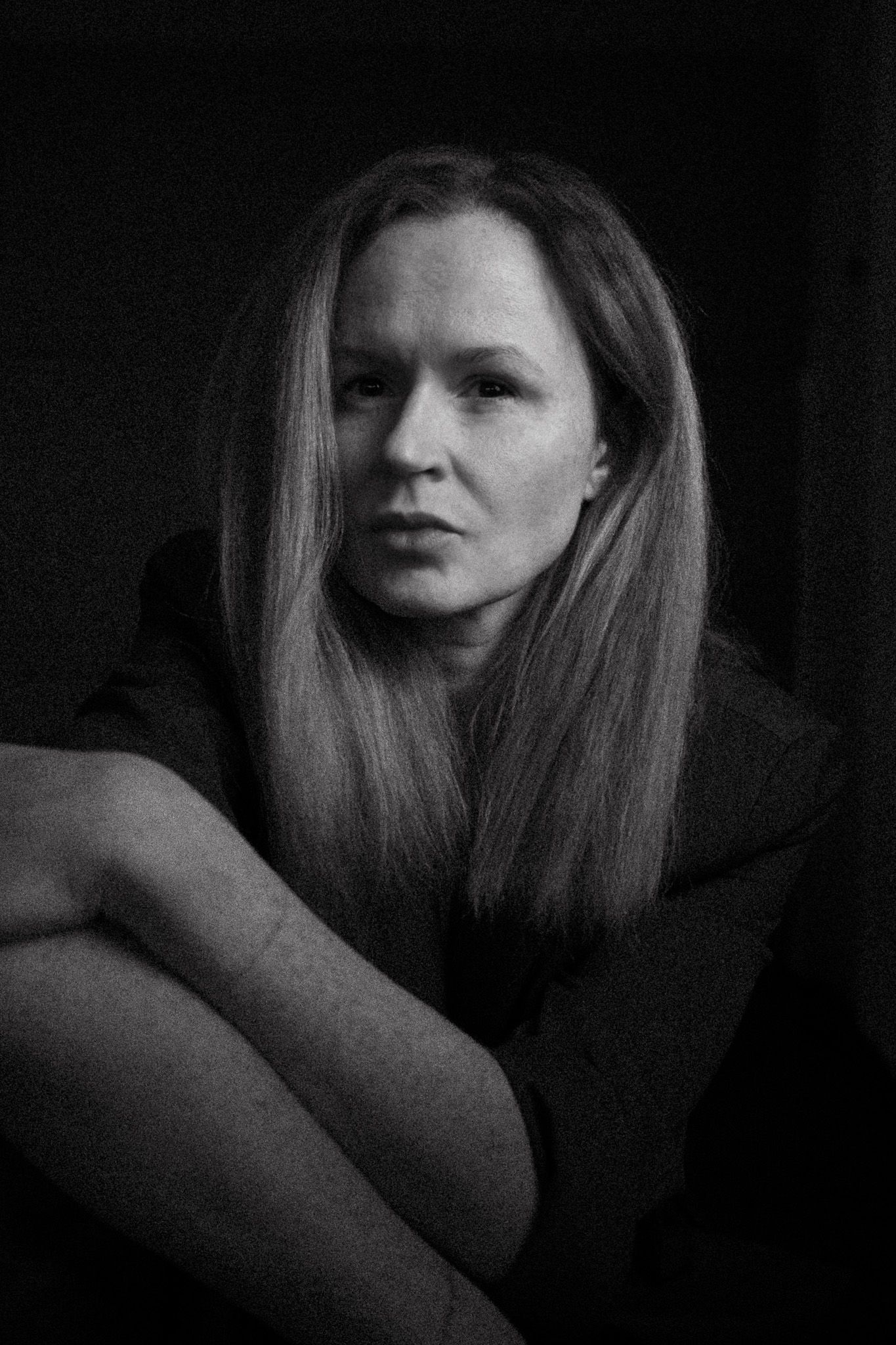 Moody black and white portrait series showing dramatic shadows and lighting effects.