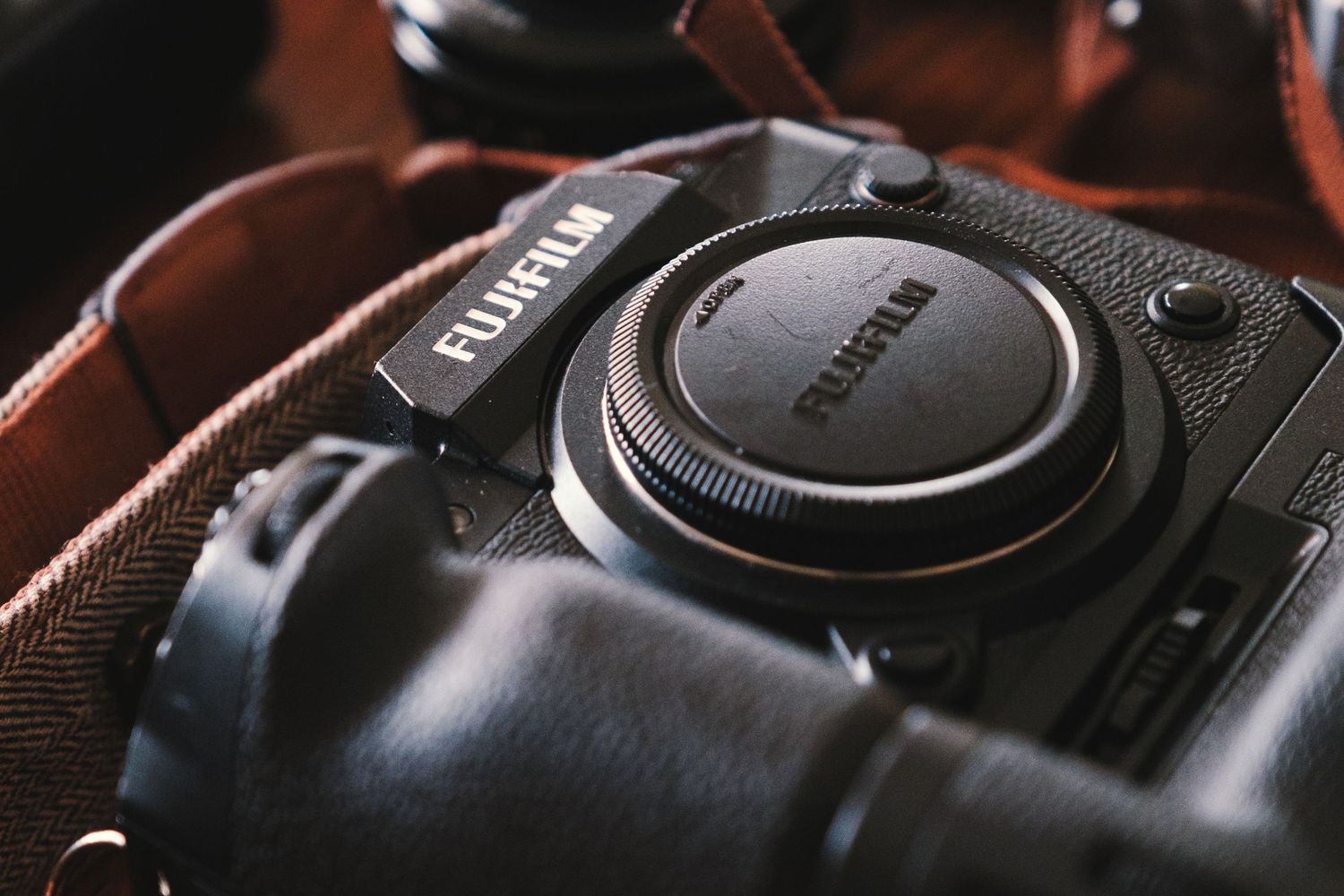 Close-up detail of professional camera body showing texture and controls.