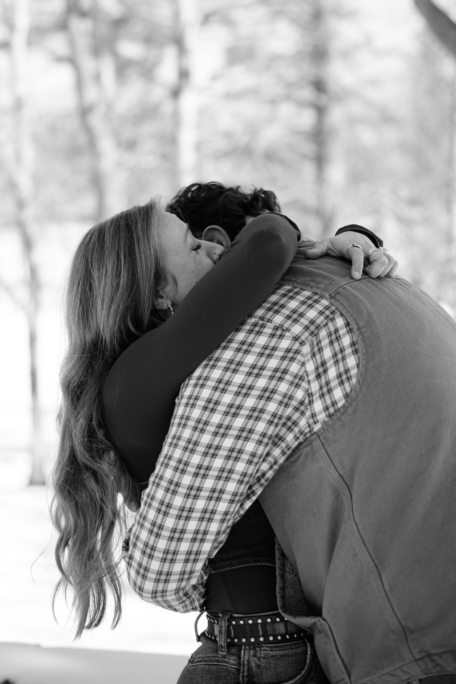 Intimate black and white photo of a couple embracing on a winter day.
