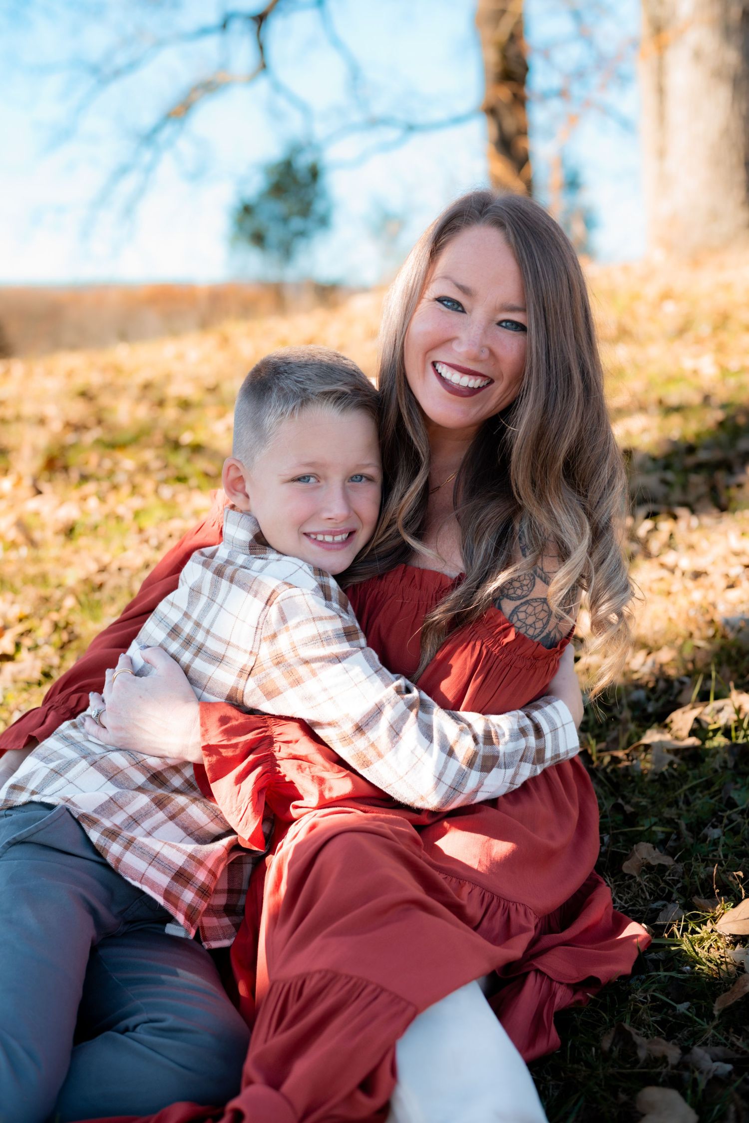 Candid autumn family photos with red clothing against fall foliage.