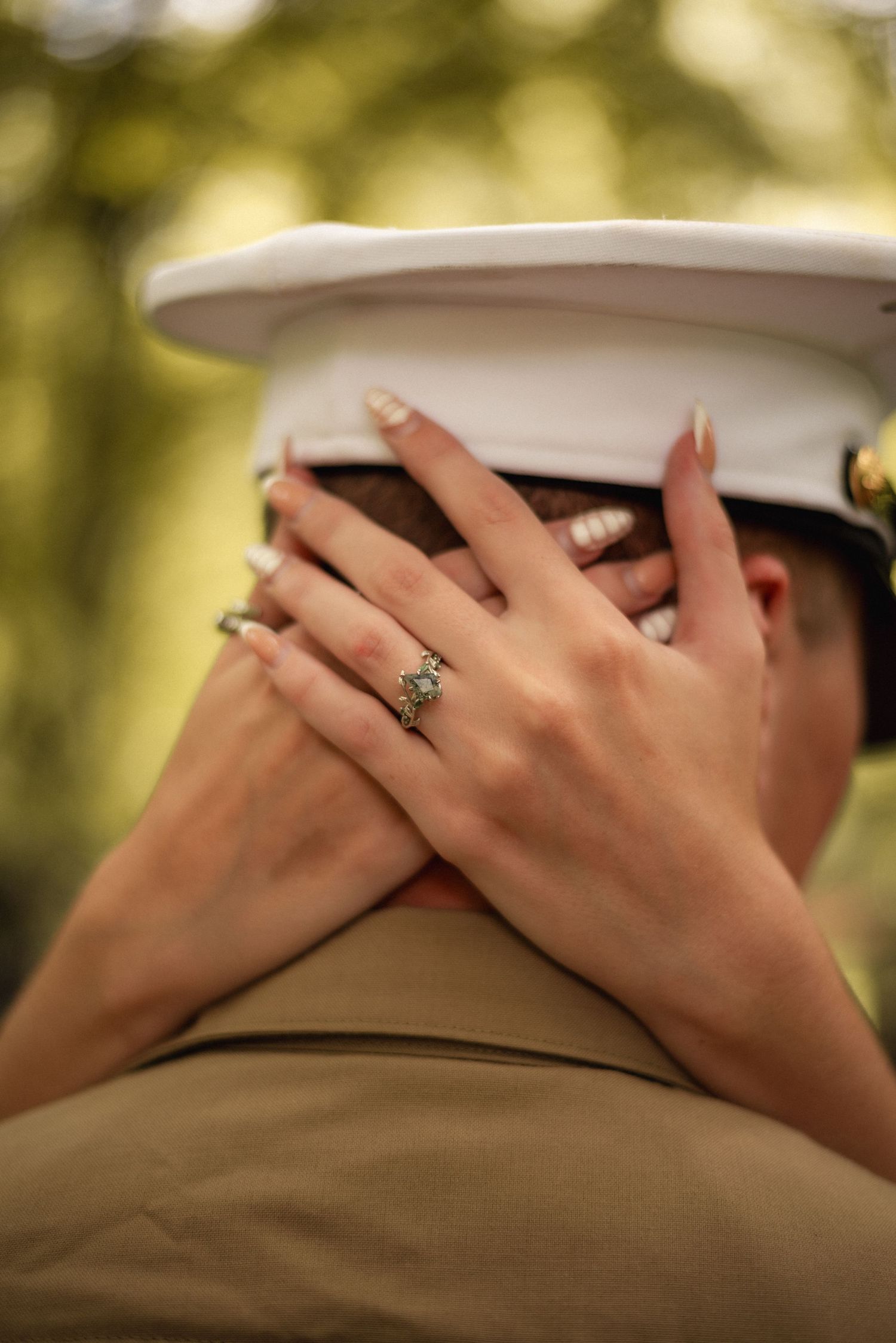 Detail shots of hands with rings against a brown uniform background.