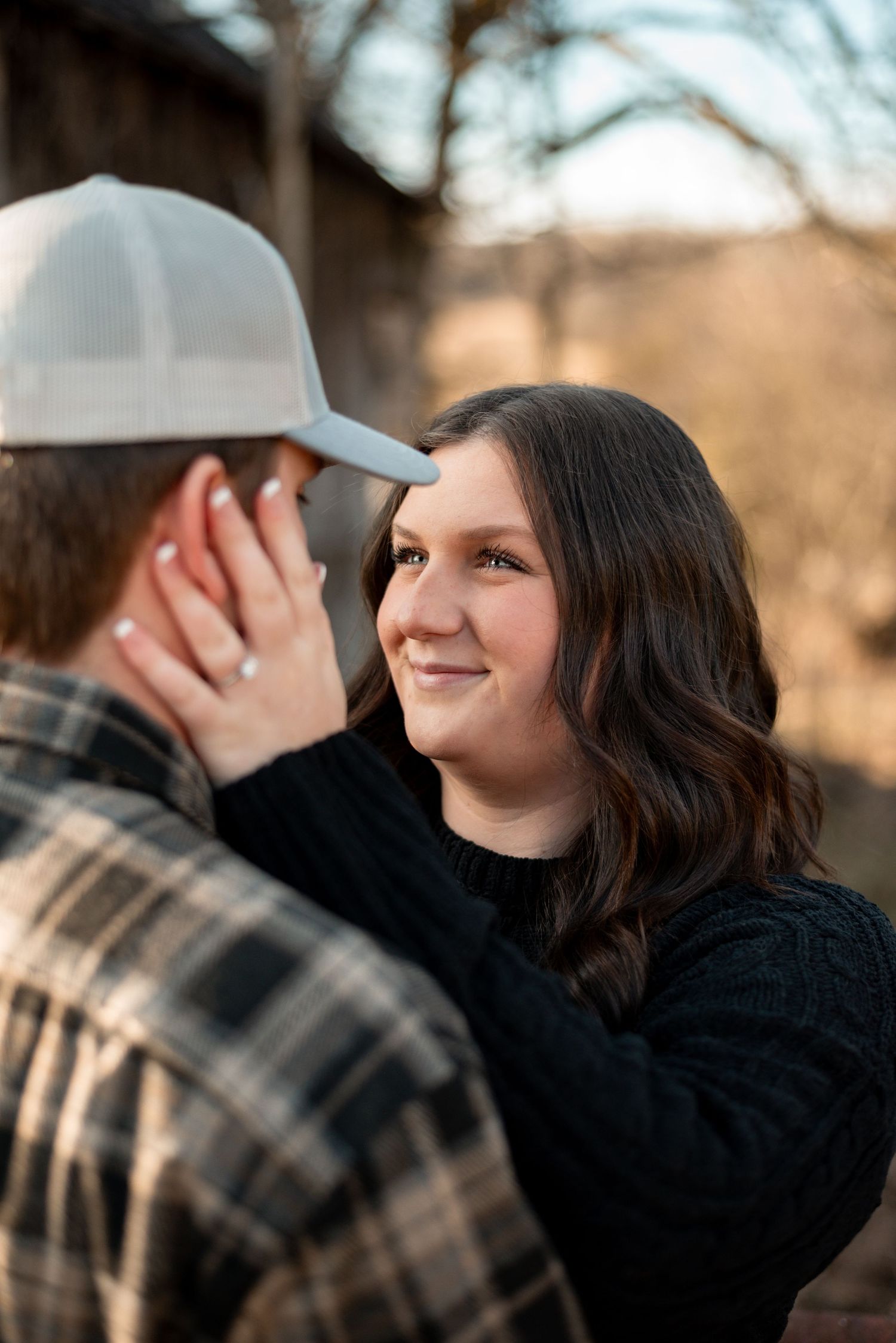 Tender moment between couple during winter engagement photoshoot.