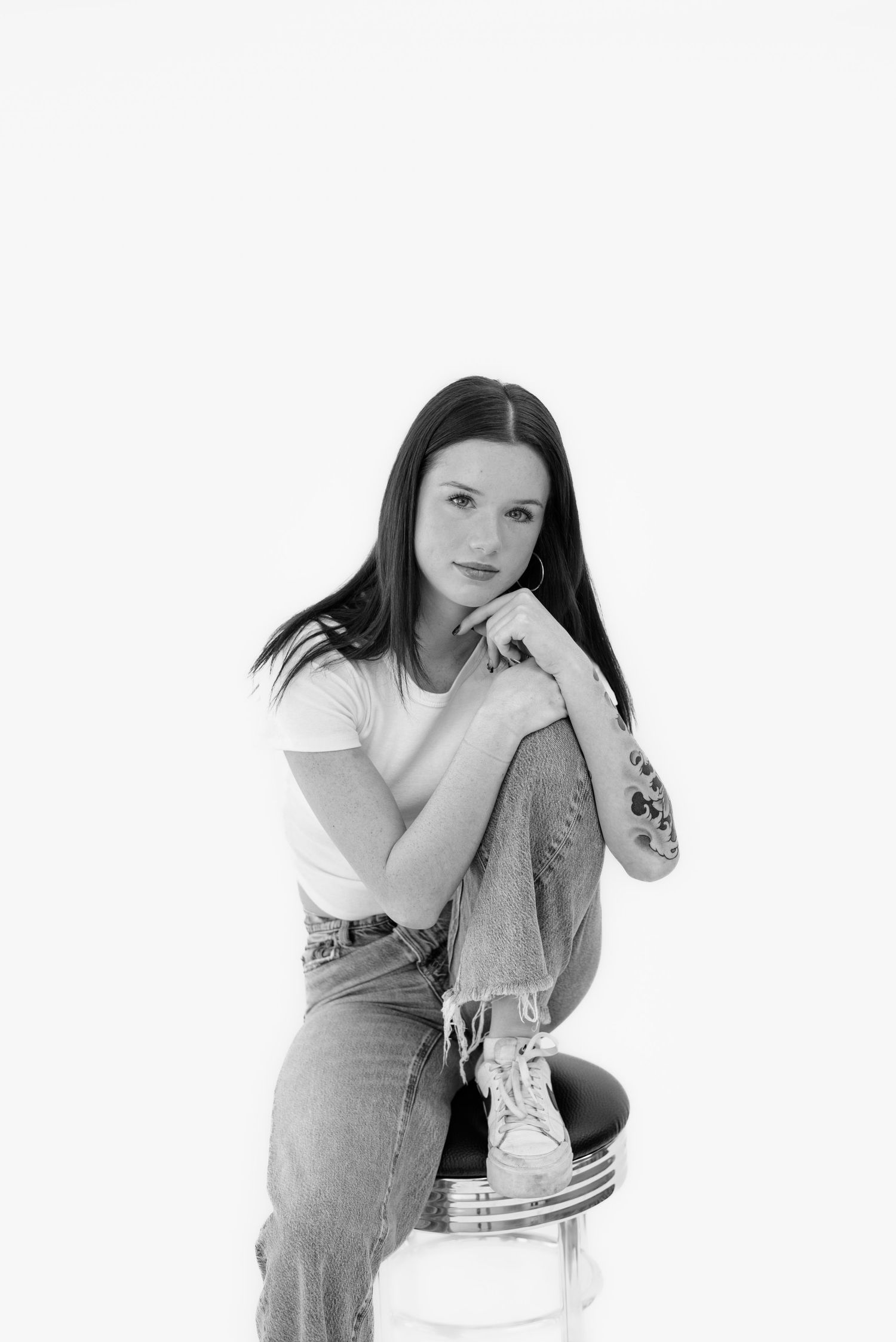 Black and white artistic portrait series showing contemplative poses against white background.