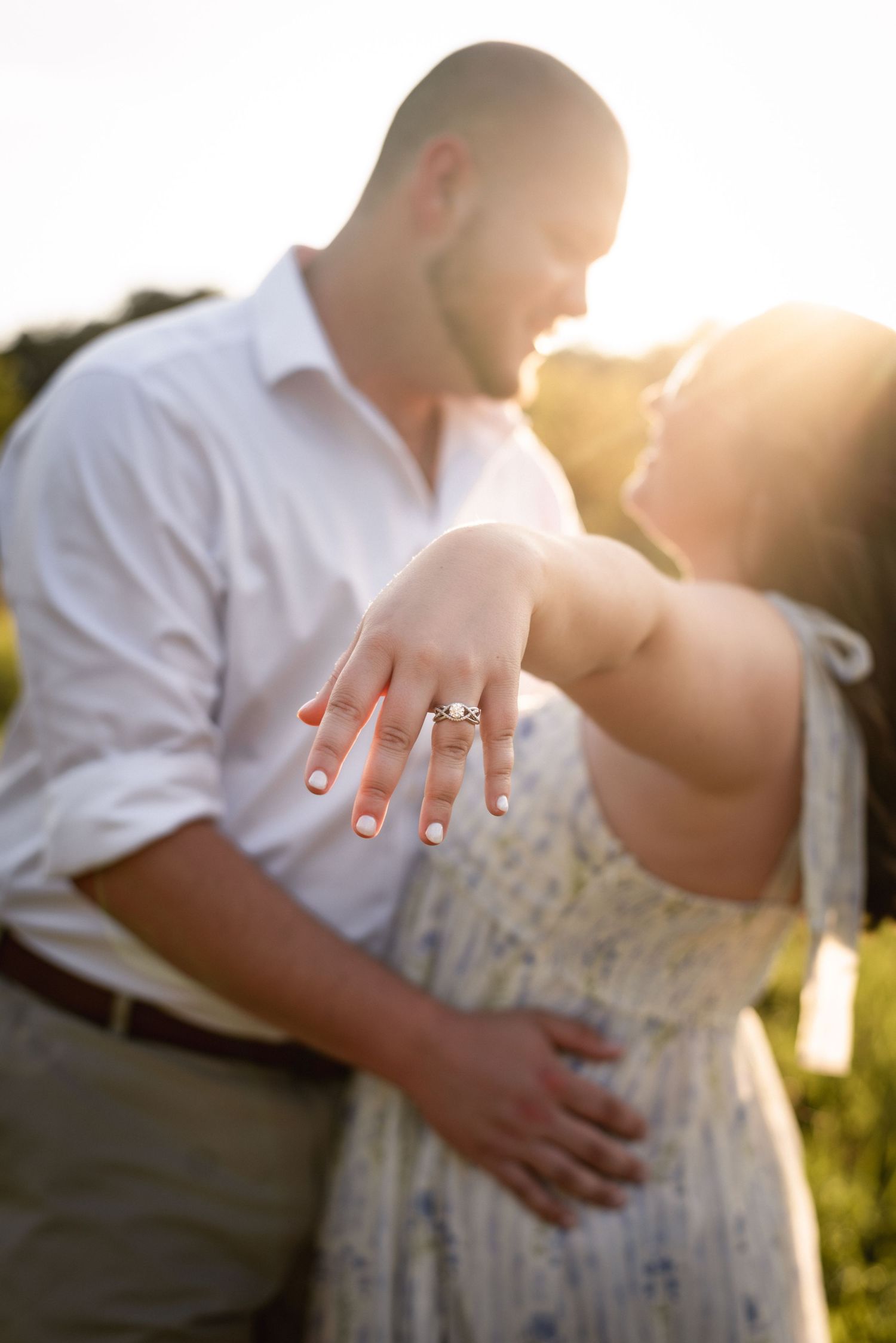 Close-up shots of engagement ring during sunset couple photo session.
