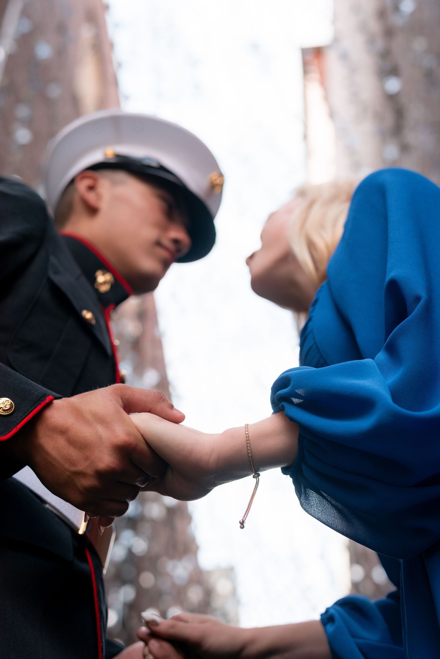 A couple shares a tender moment during a snowy winter engagement photo session.