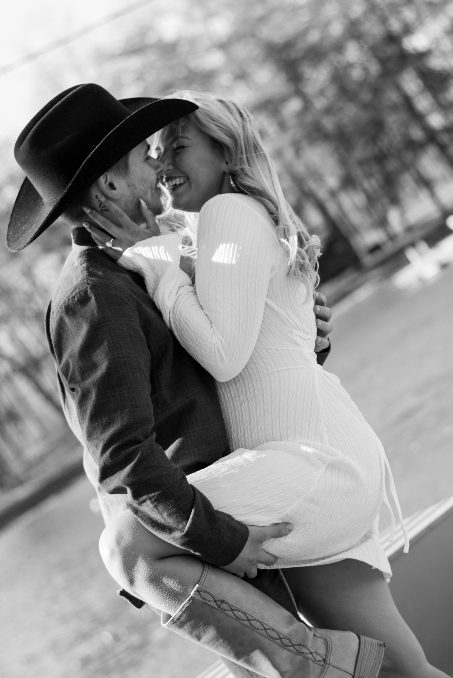 Romantic black and white photo of couple embracing in winter clothing.